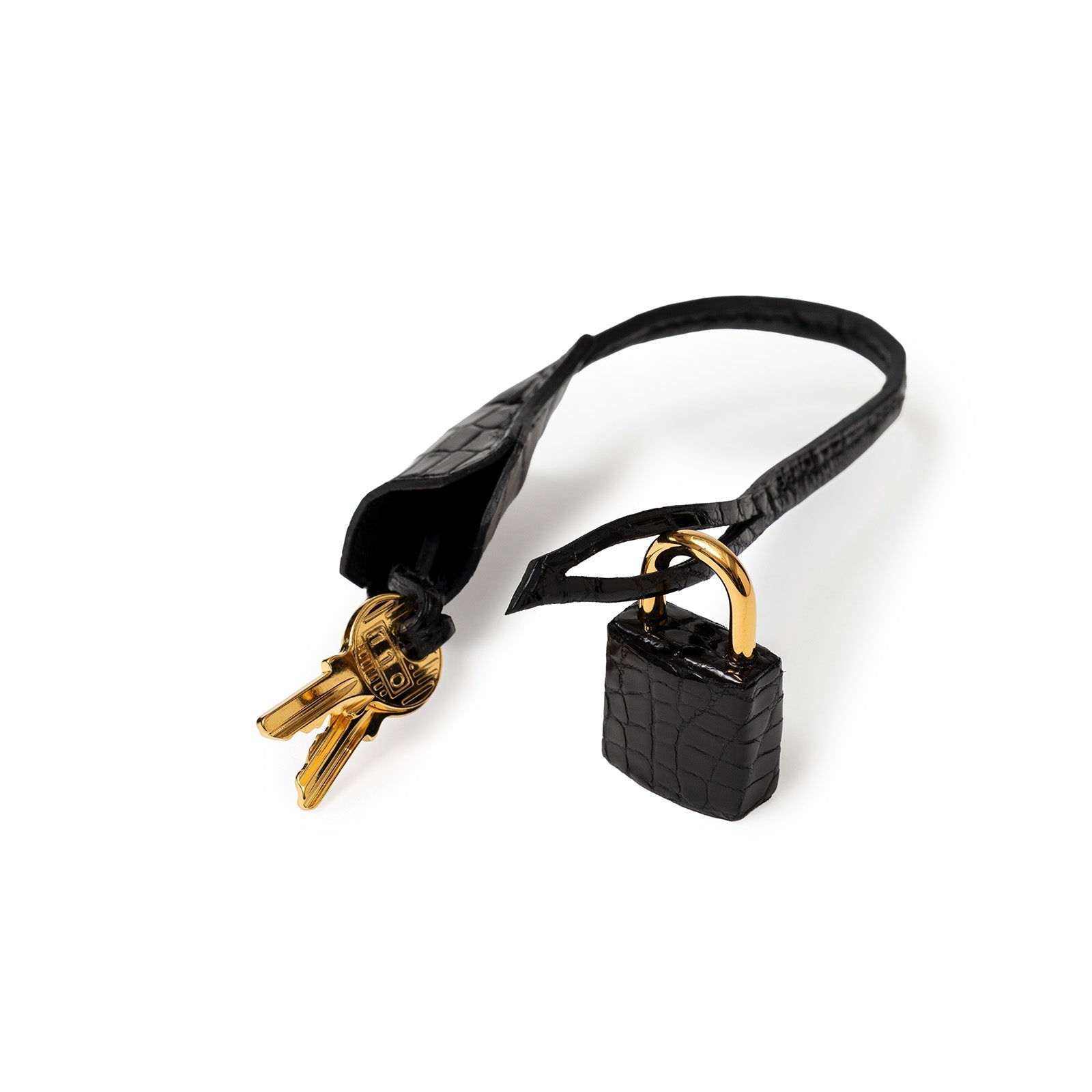 Close-up of Hermès Birkin 30 Black Shiny Porosus Crocodile gold hardware lock and two keys with leather clochette.