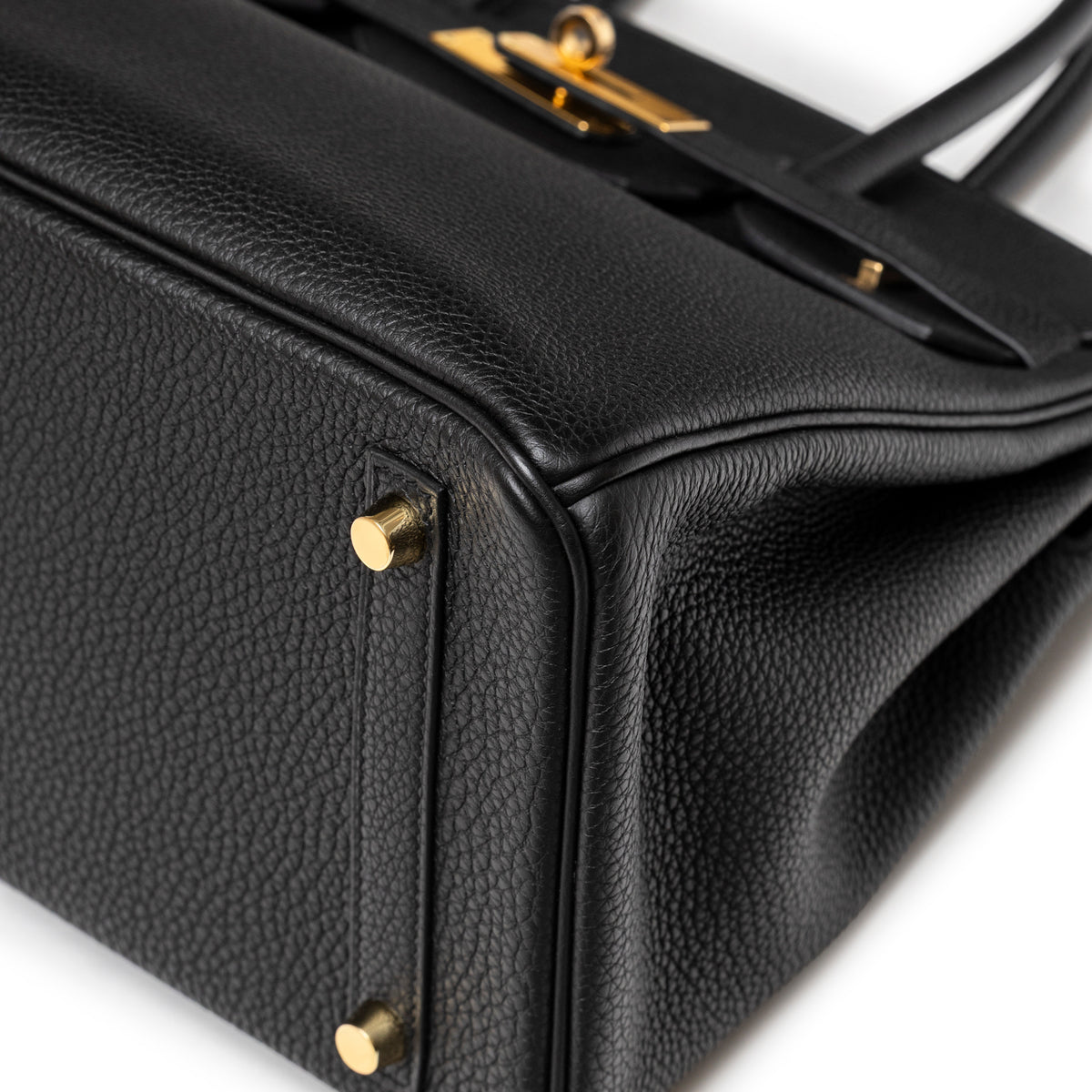 Close-up of Hermès Birkin 30 Black Togo Gold Hardware corner showing textured leather and polished gold feet details