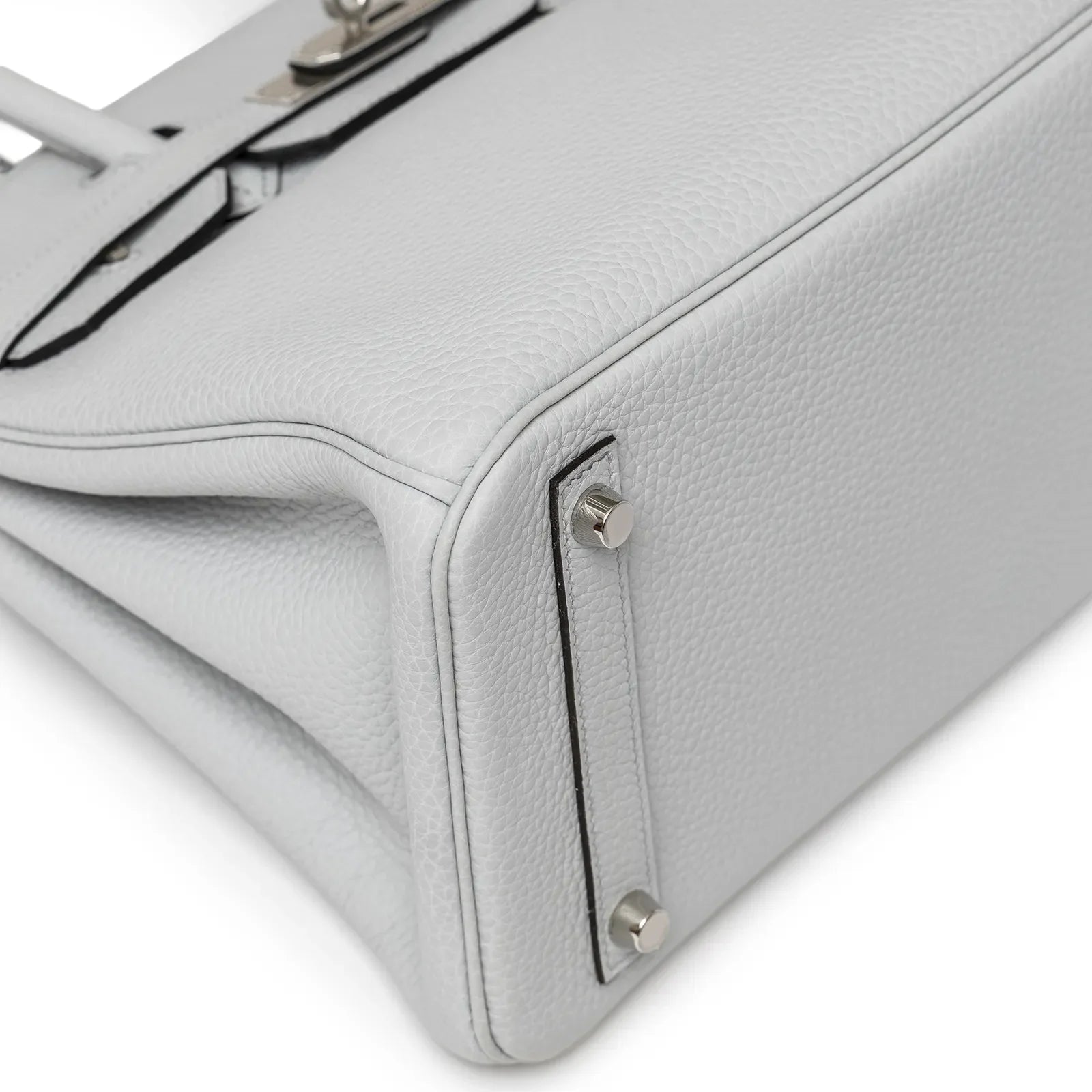 Close-up angled view of the pale blue leather Hermès Birkin 30 showing bottom corner and palladium feet details