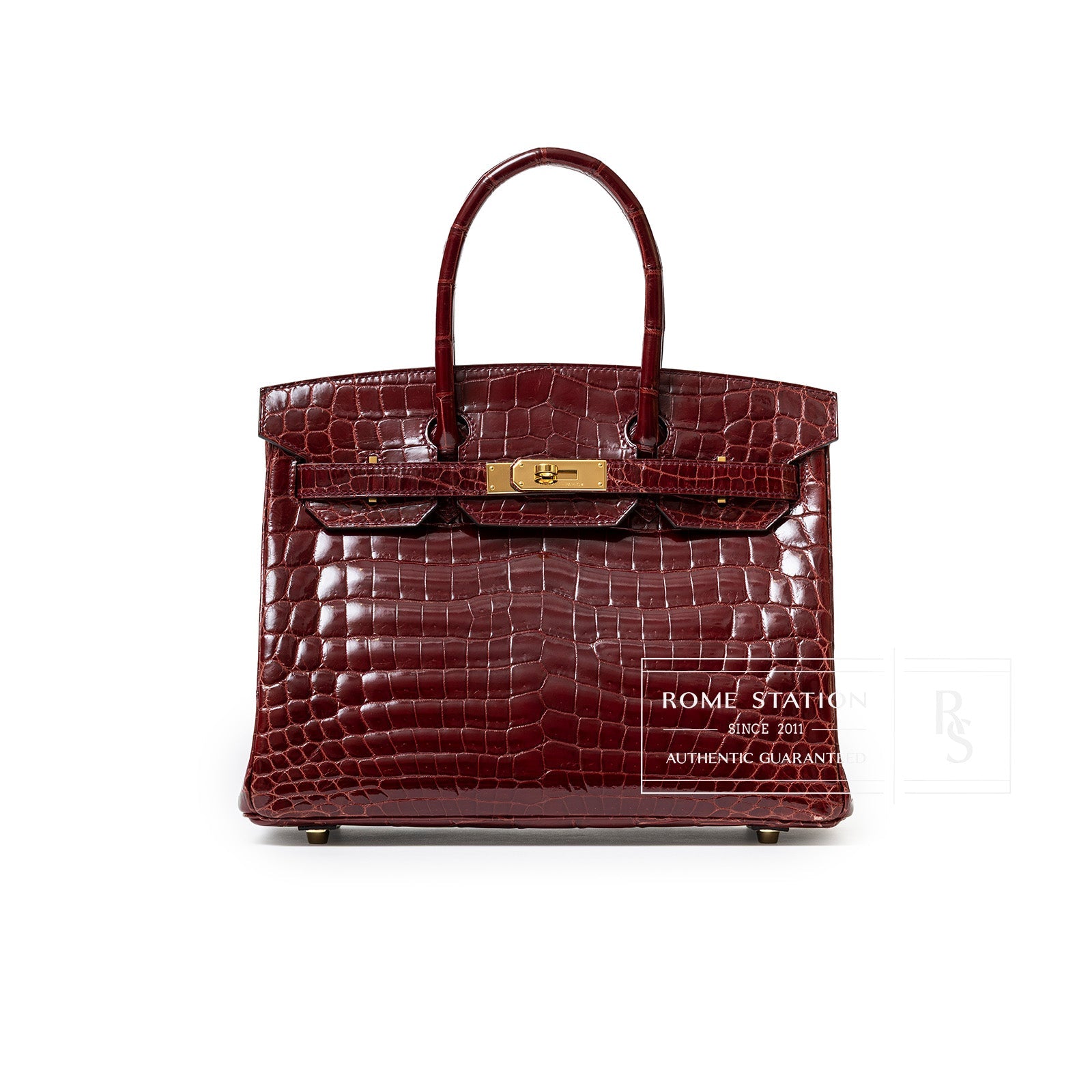 Front view of Hermès Birkin 30 in shiny Bourgogne Niloticus crocodile with gold hardware and rolled handles.