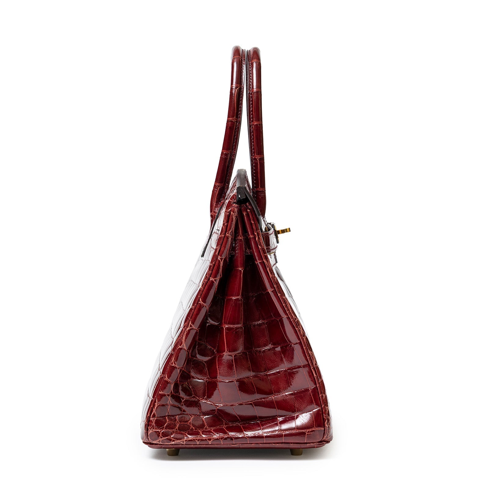 Side view of Hermès Birkin 30 in shiny bourgogne Niloticus crocodile with gold hardware and double handles