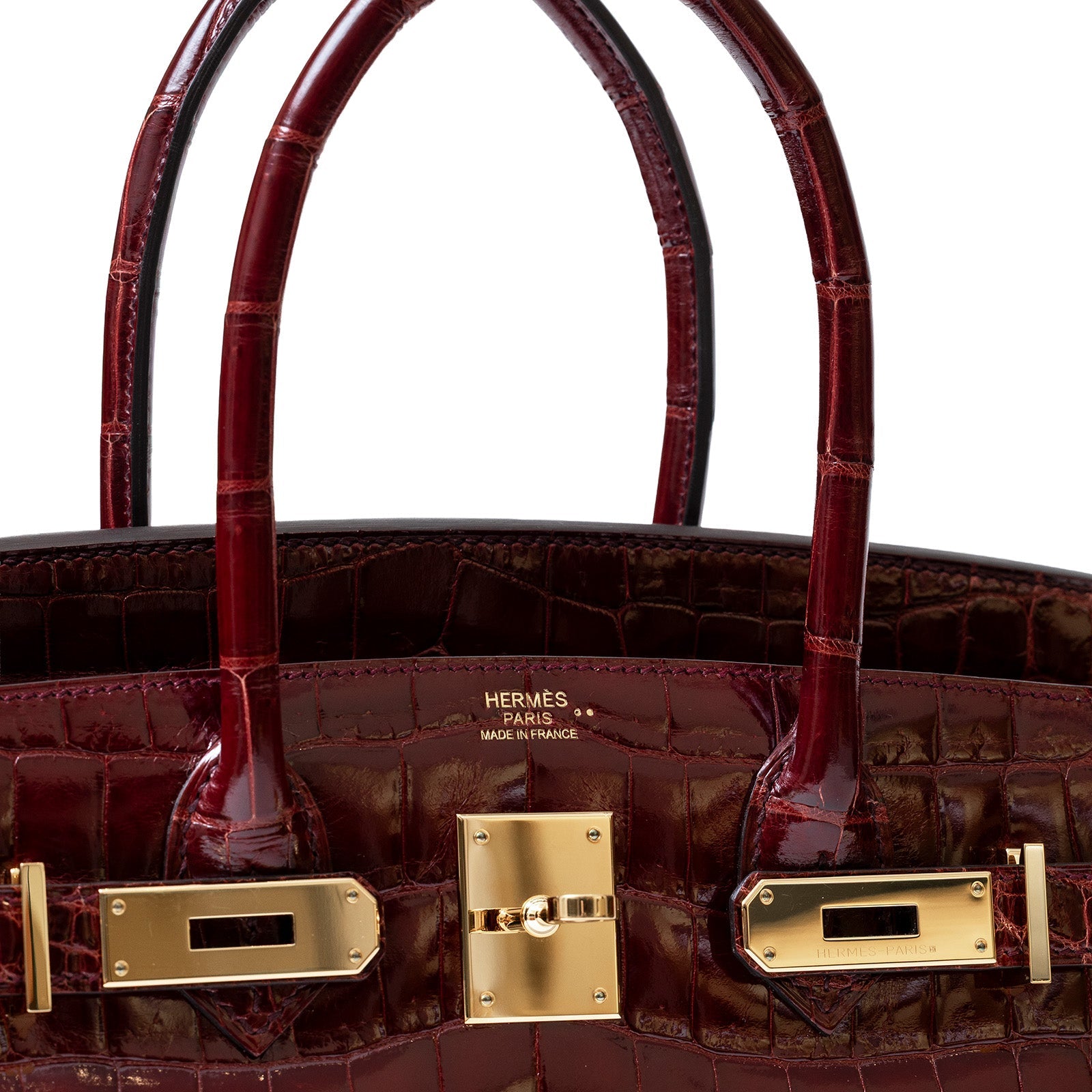 Close-up front view of Hermès Birkin 30 in shiny Bourgogne Niloticus crocodile leather with gold hardware