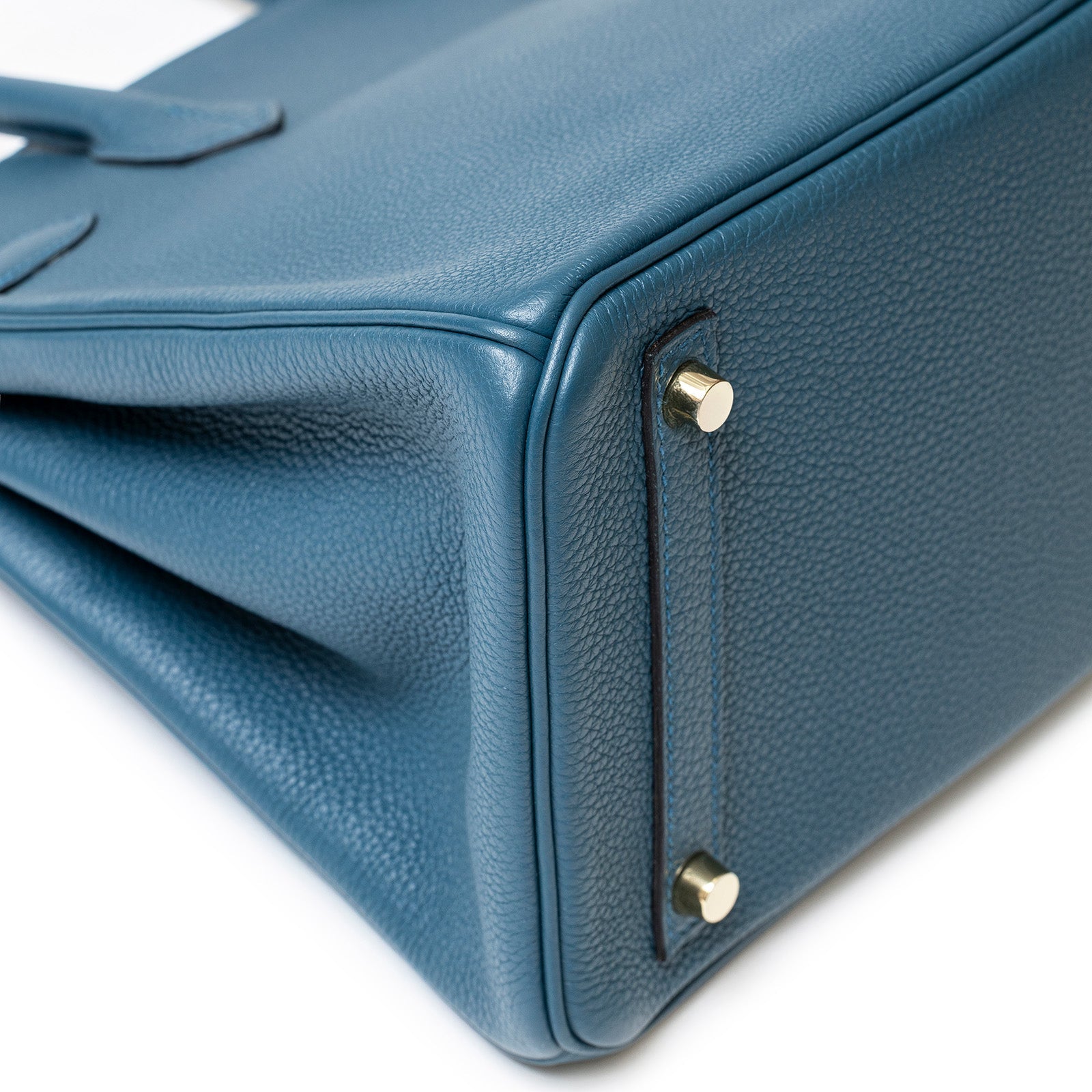 Close-up bottom view of Hermès Birkin 30 Colvert Togo leather with gold hardware and protective feet.