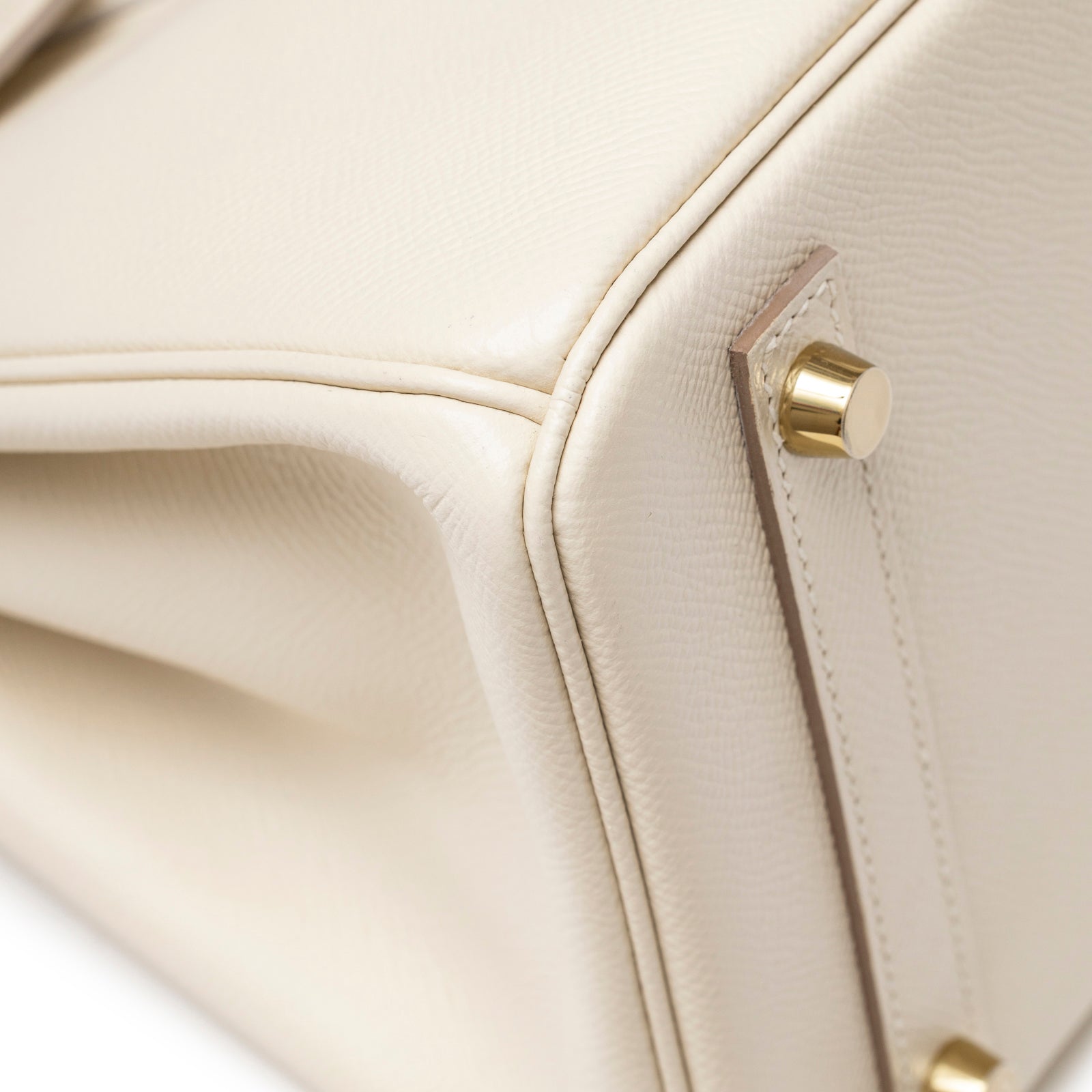 Close-up of Hermès Birkin 30 Craie Epsom Gold Hardware base corner showing cream leather and gold feet details