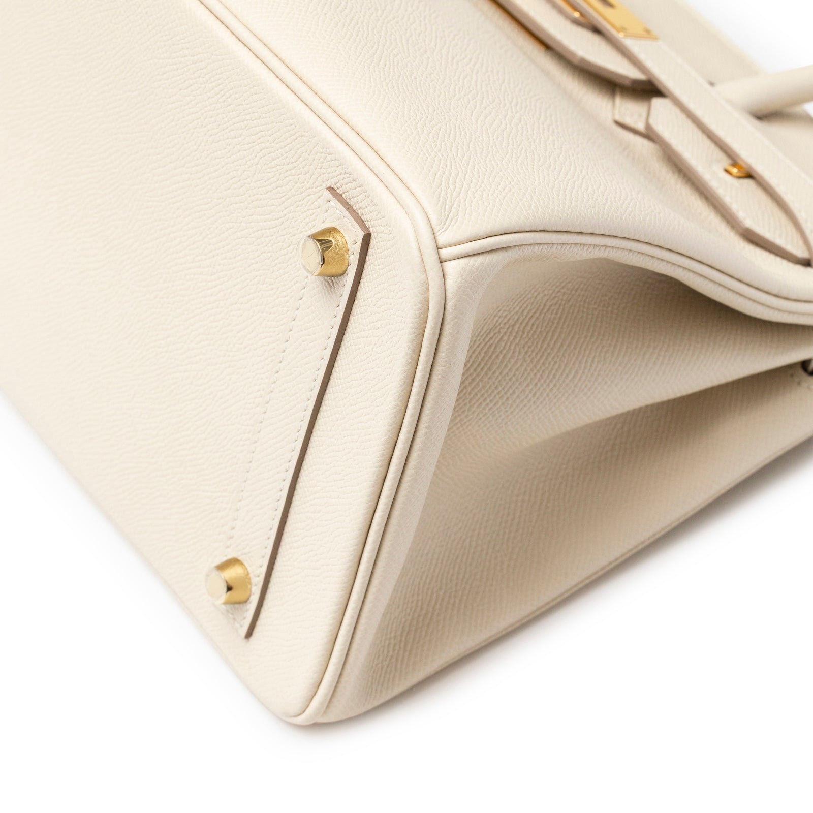 Close-up angled view of Hermès Birkin 30 Craie Epsom Gold Hardware showing bottom corner and protective feet