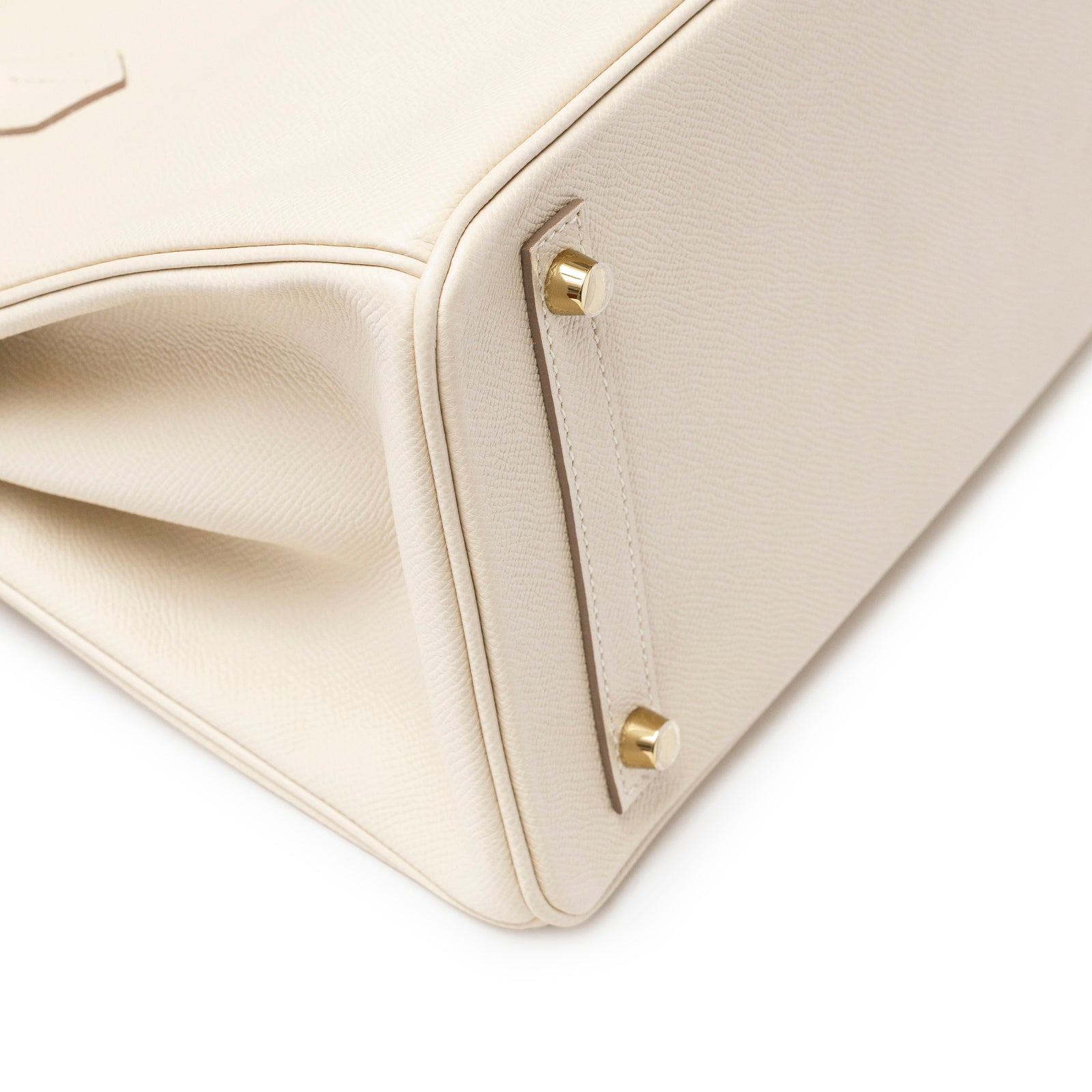 Close-up of bottom corner showing gold hardware feet on Hermès Birkin 30 Craie Epsom Gold Hardware