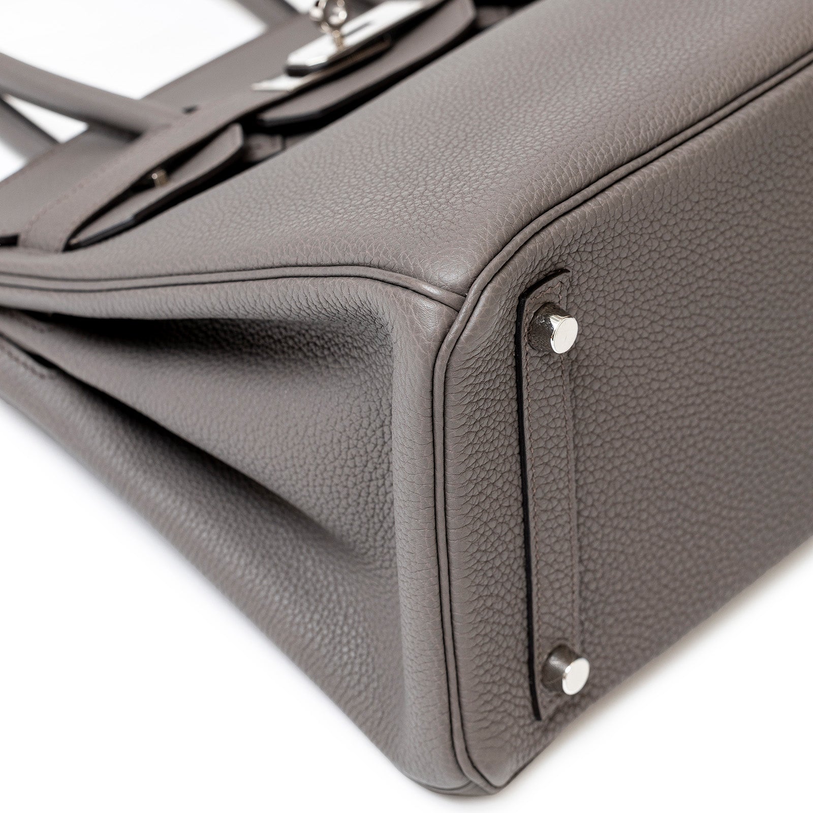 Close-up of bottom corner and palladium hardware on Hermès Birkin 30 Etain Togo leather handbag