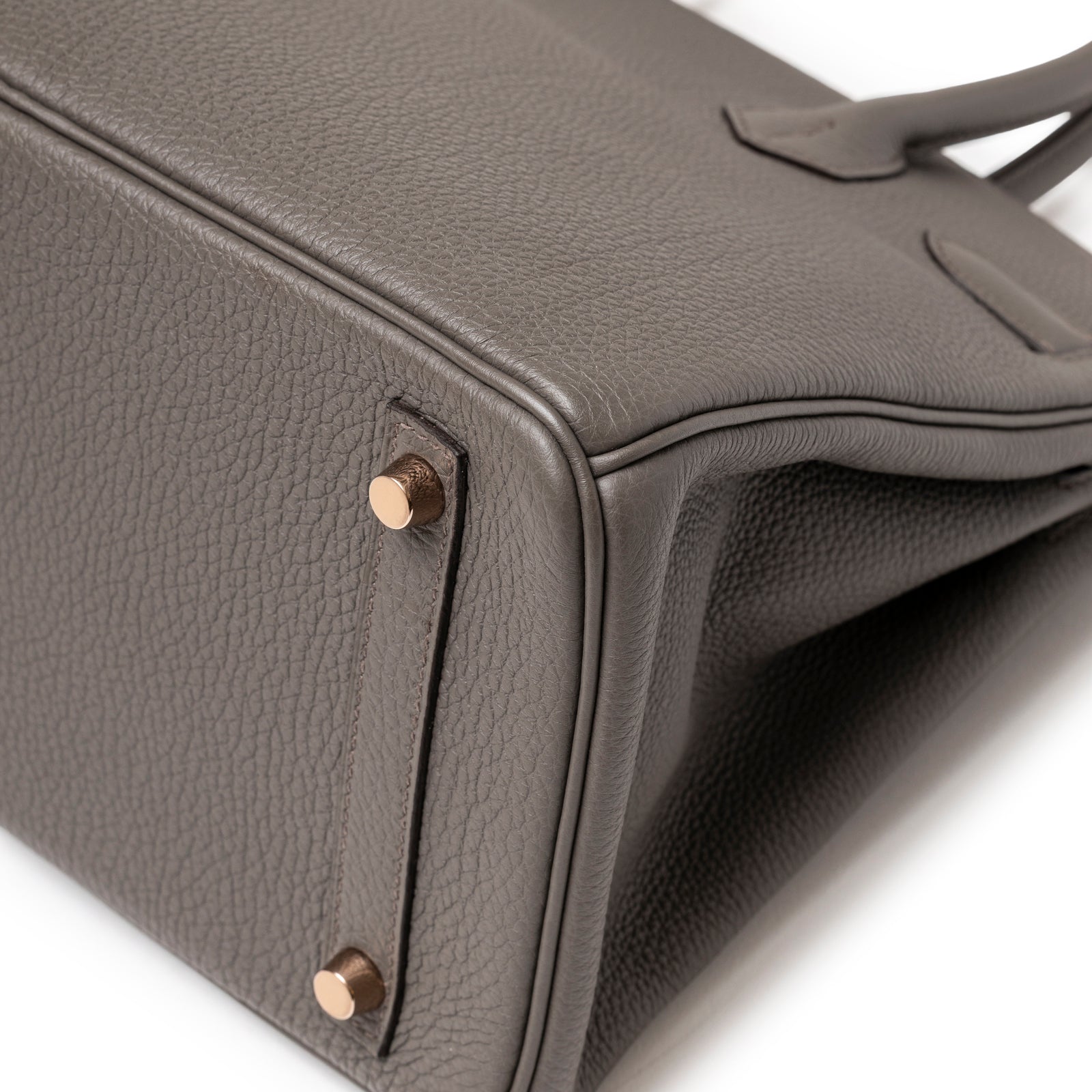 Bottom corner close-up of Hermès Birkin 30 Etain Togo Rose Gold Hardware showing textured leather and feet detail