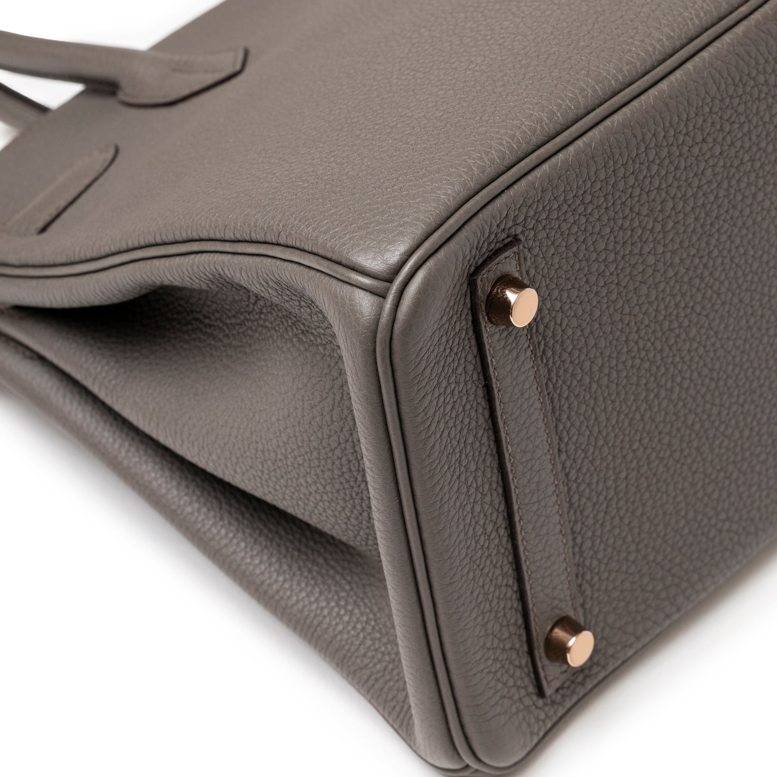 Close-up of bottom corner on Hermès Birkin 30 Etain Togo Rose Gold Hardware showing textured leather and polished feet