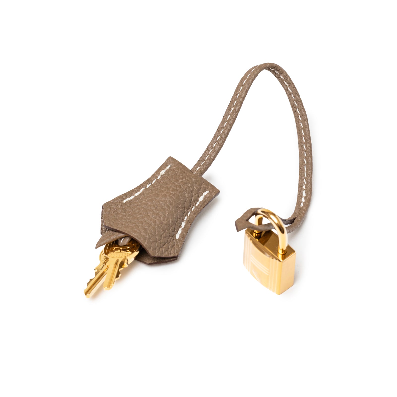 Close-up of Hermès Birkin 30 Etoupe Togo Gold Hardware leather clochette with gold key and lock accessory