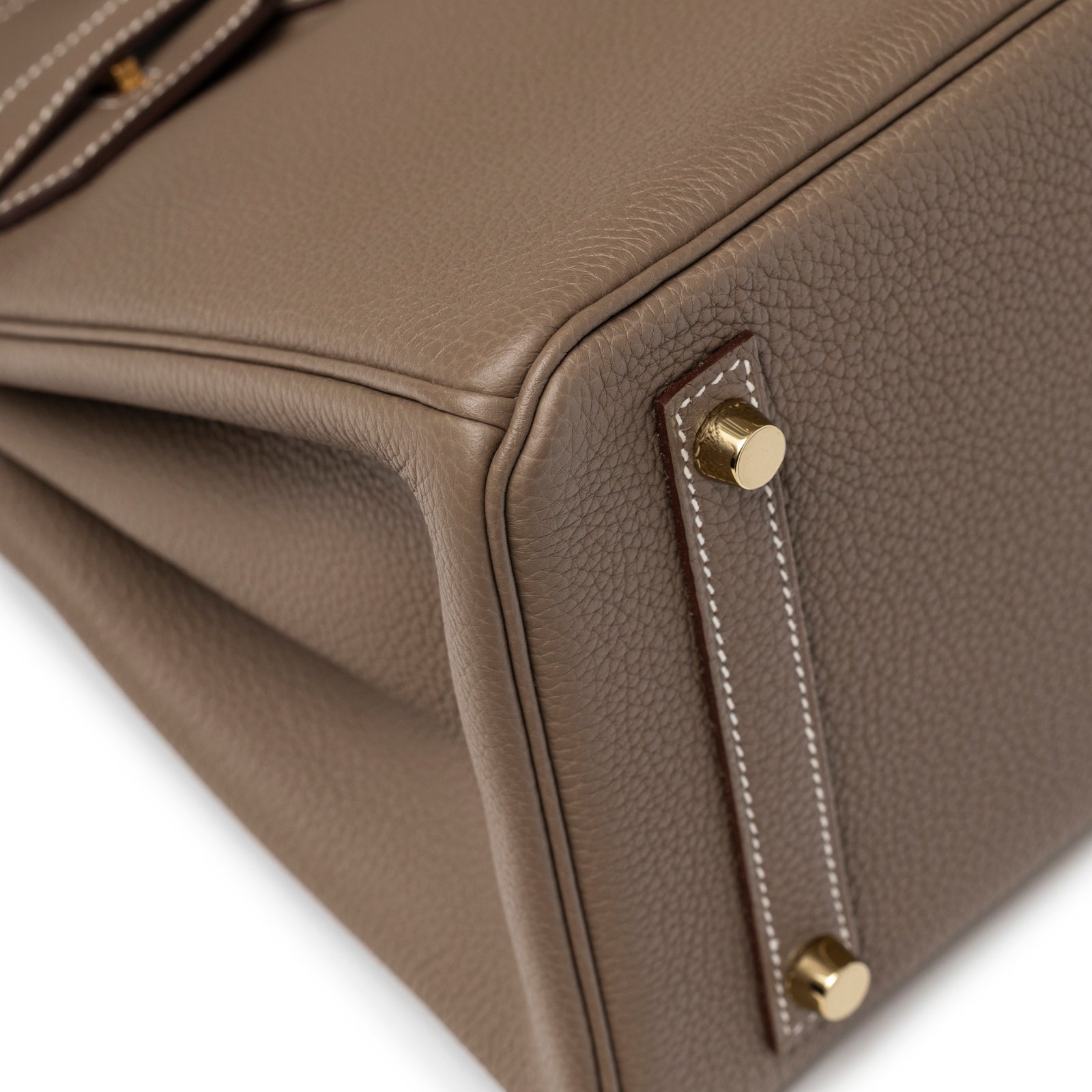 Close-up of corner stitching and gold feet hardware on Hermès Birkin 30 Etoupe Togo Gold Hardware handbag