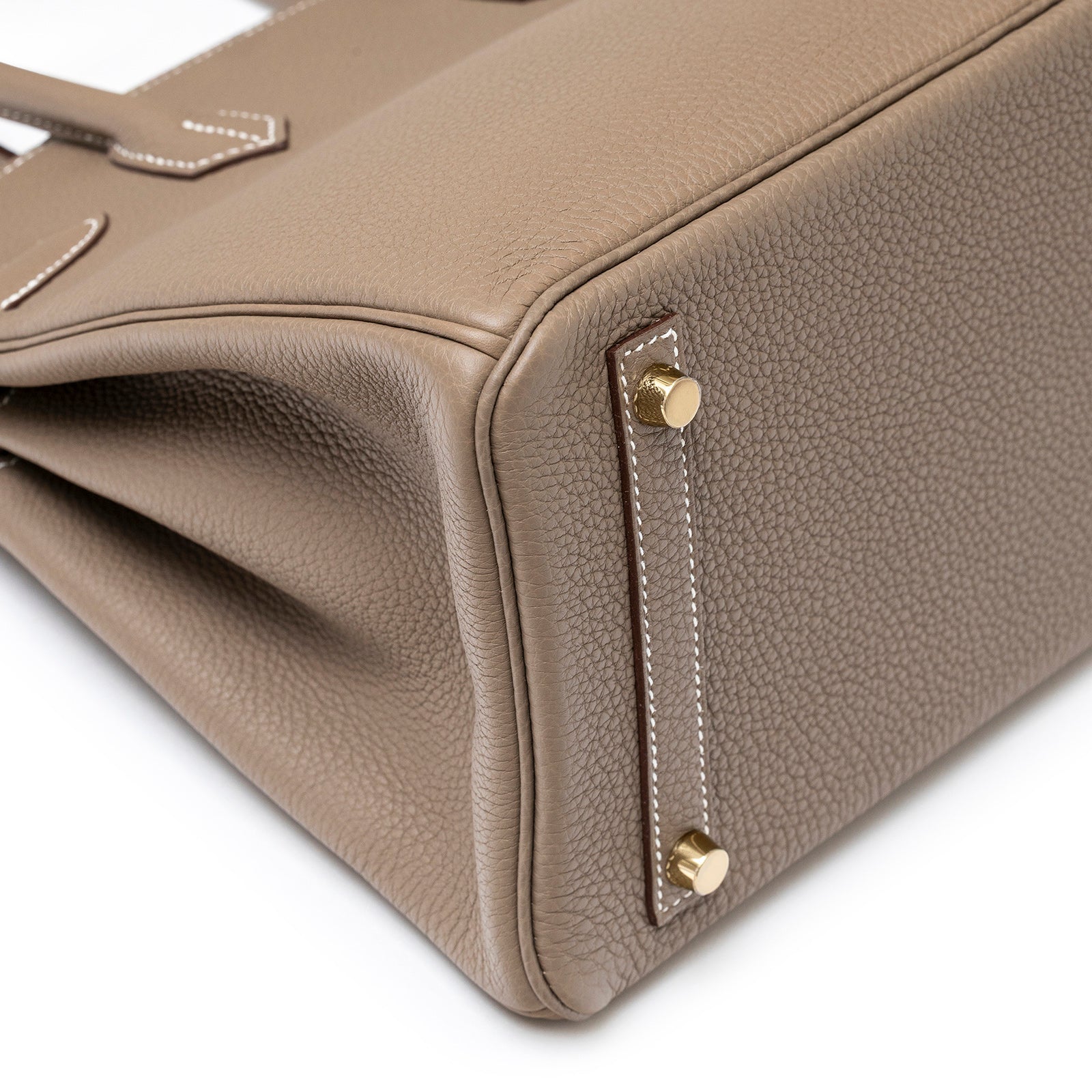Close-up bottom view of Hermès Birkin 30 Etoupe Togo Gold Hardware showing leather texture and gold feet studs
