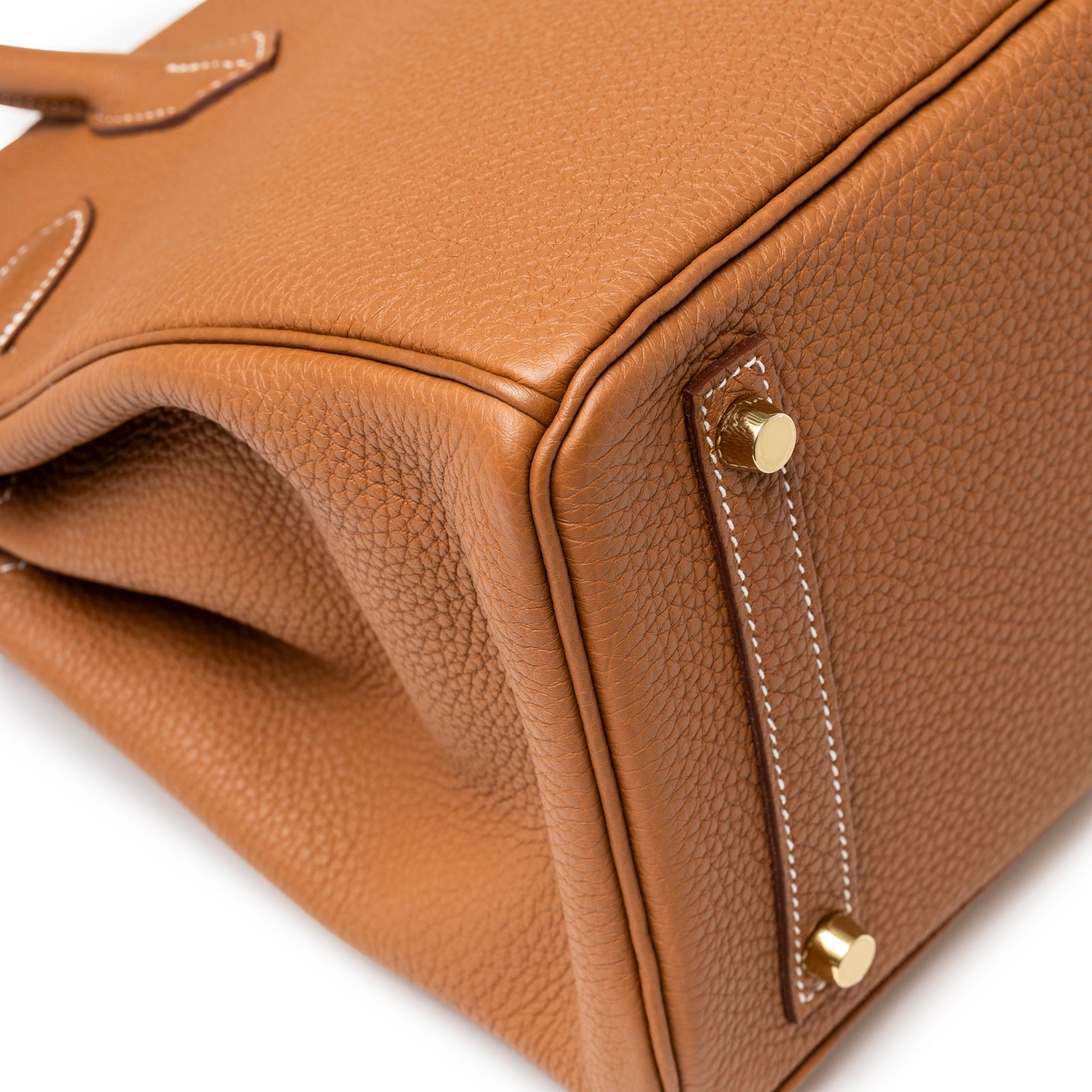 Close-up of Hermès Birkin 30 Gold Togo Gold Hardware focusing on the pebbled leather and gold protective feet details.