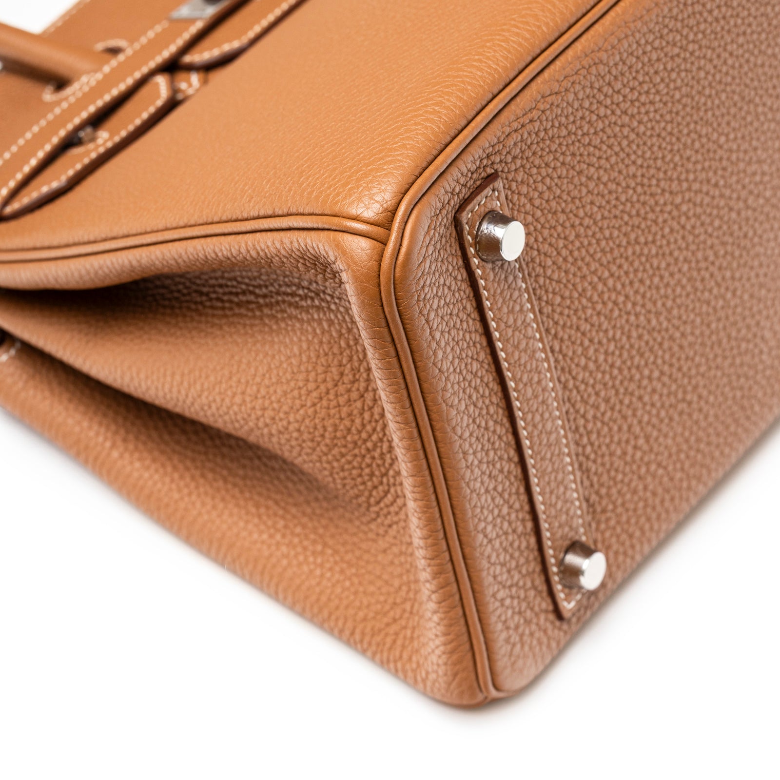 Close-up angled shot of the bottom corner showing the textured leather and palladium hardware of Hermès Birkin 30 Gold Togo Palladium Hardware