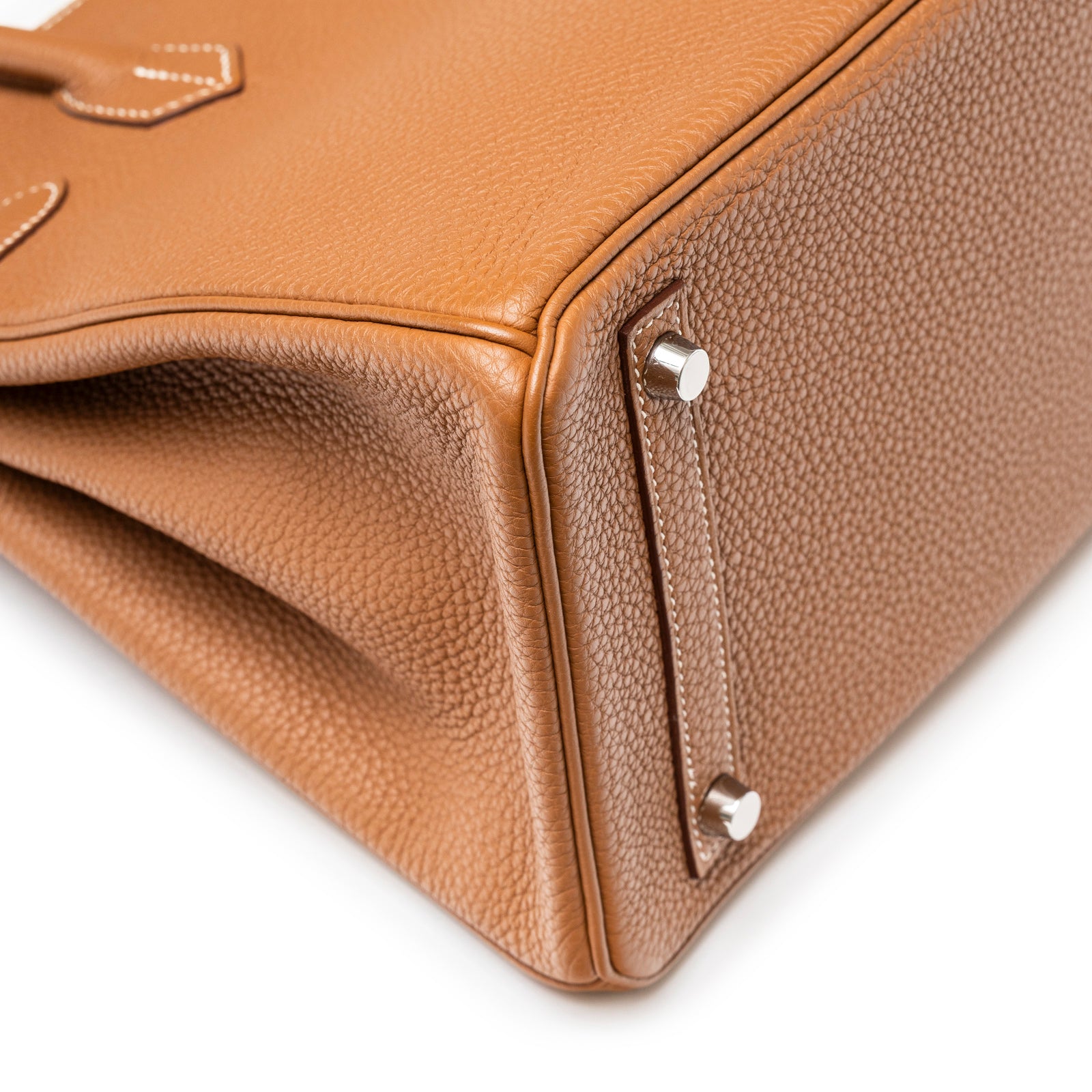 Close-up of bottom corner and metal feet on Hermès Birkin 30 Gold Togo Palladium Hardware handbag