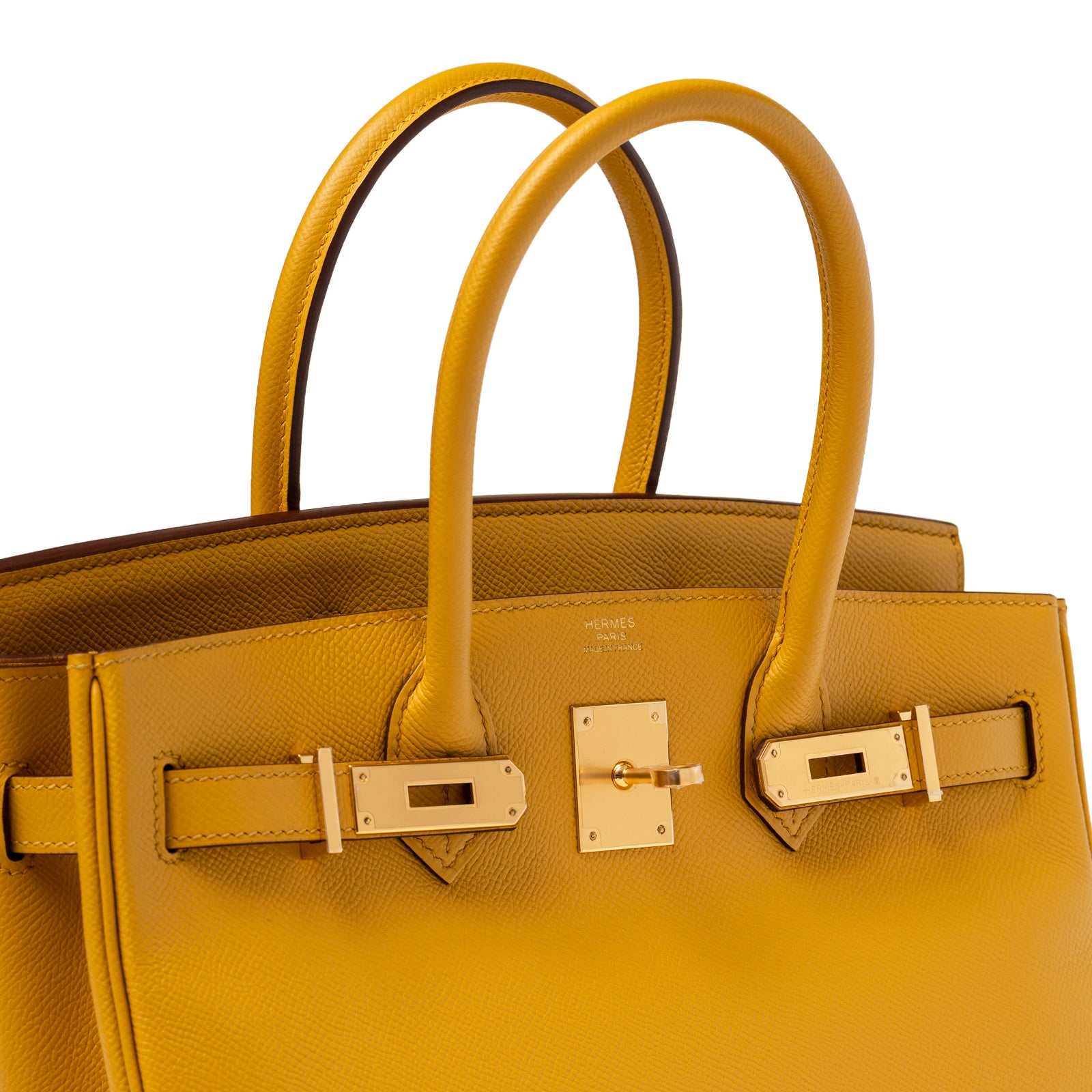 Angled close-up of Hermès Birkin 30 Jaune Ambre Epsom Gold Hardware showing textured leather and gold clasp details