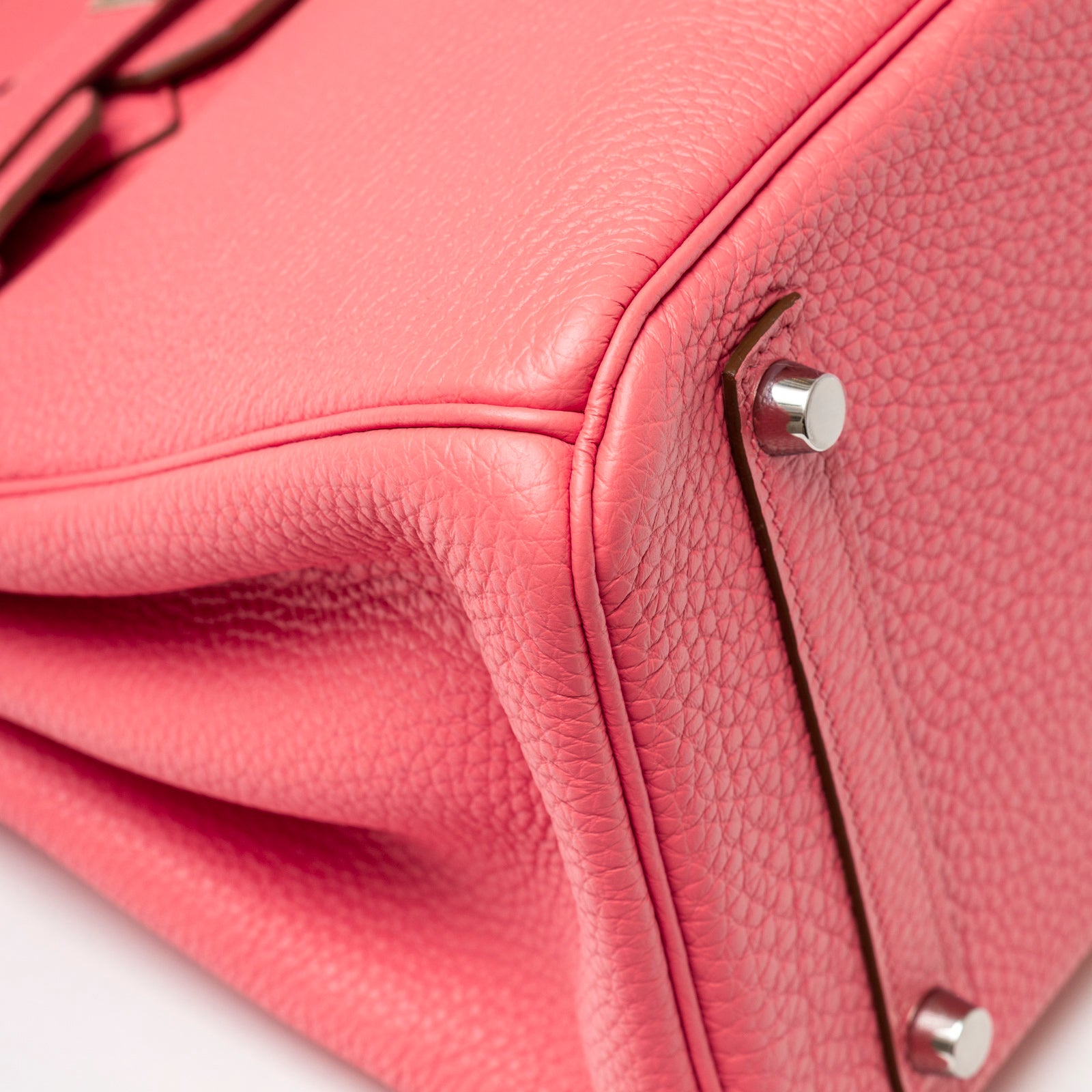 Close-up of Hermès Birkin 30 Rose Lipstick Togo Palladium Hardware showing textured leather and metal studs on the base