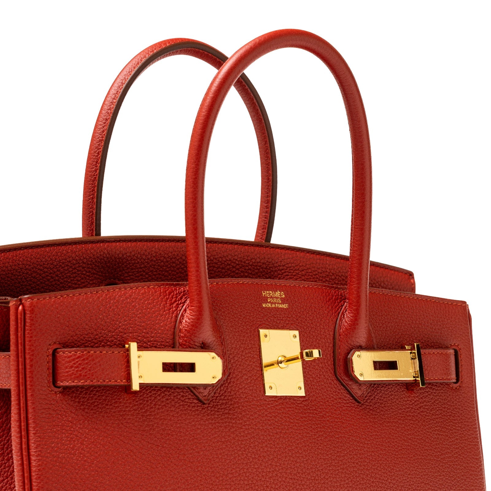 Close-up of Hermès Birkin 30 Rouge Togo with gold hardware showing top handles and lock detail