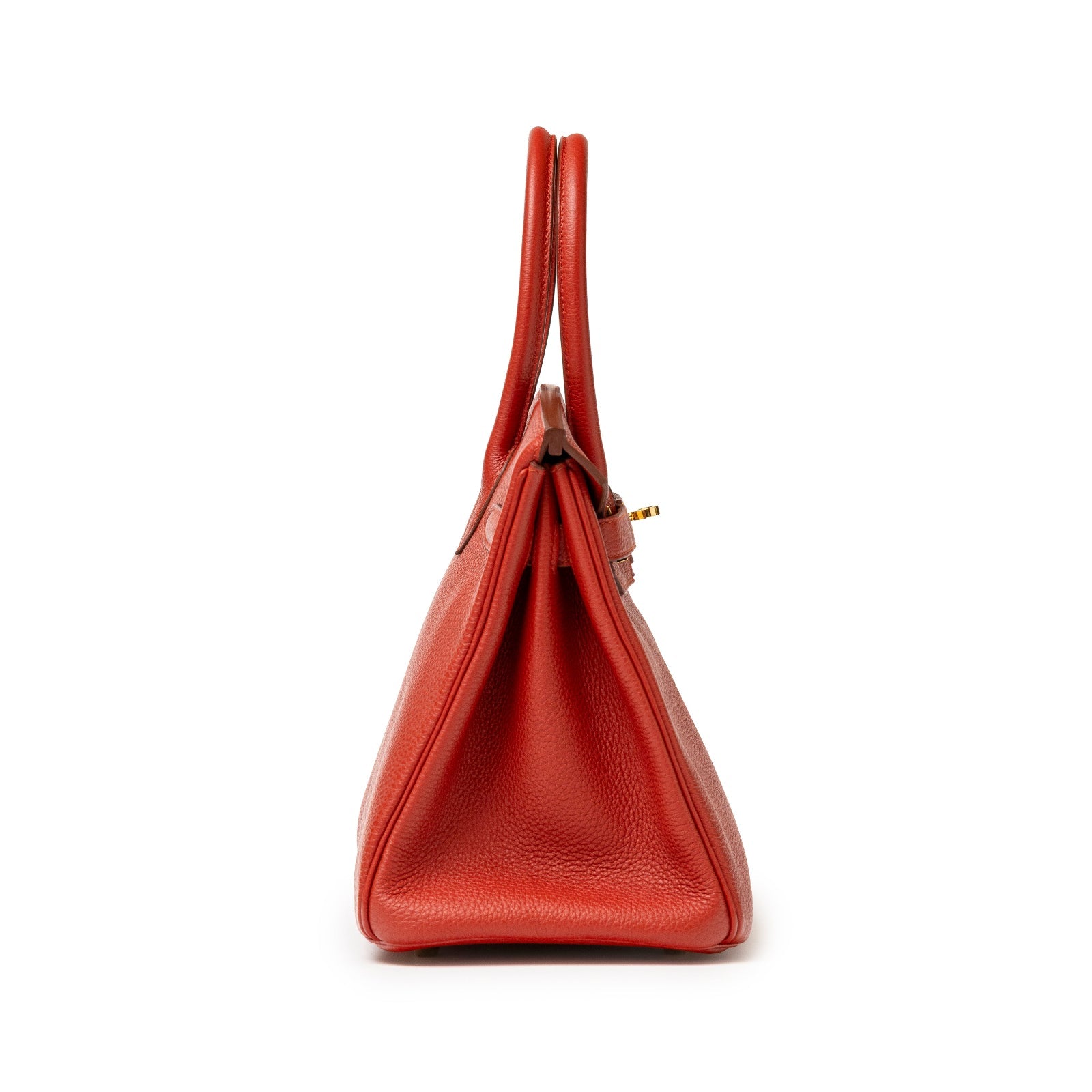 Side view of Hermès Birkin 30 Rouge Togo leather handbag with gold hardware and rounded handles.