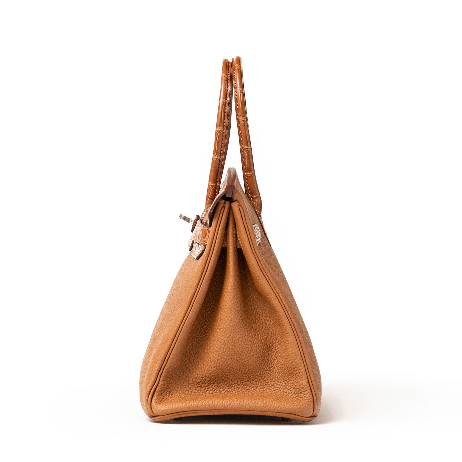 Side profile of Hermès Birkin 30 in gold togo leather with matte alligator handles and palladium hardware details