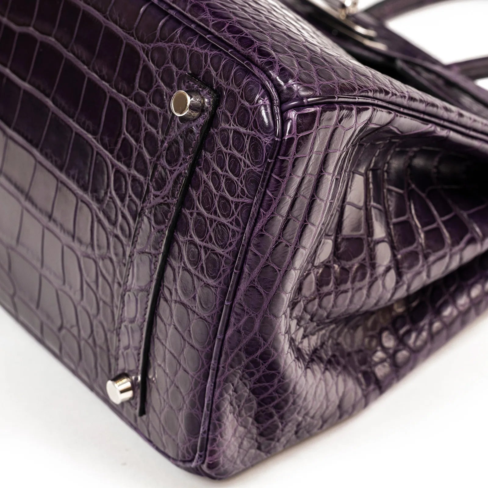 Close-up angled shot of Hermès Birkin 35 Amethyste Matte Alligator with palladium hardware corner details.