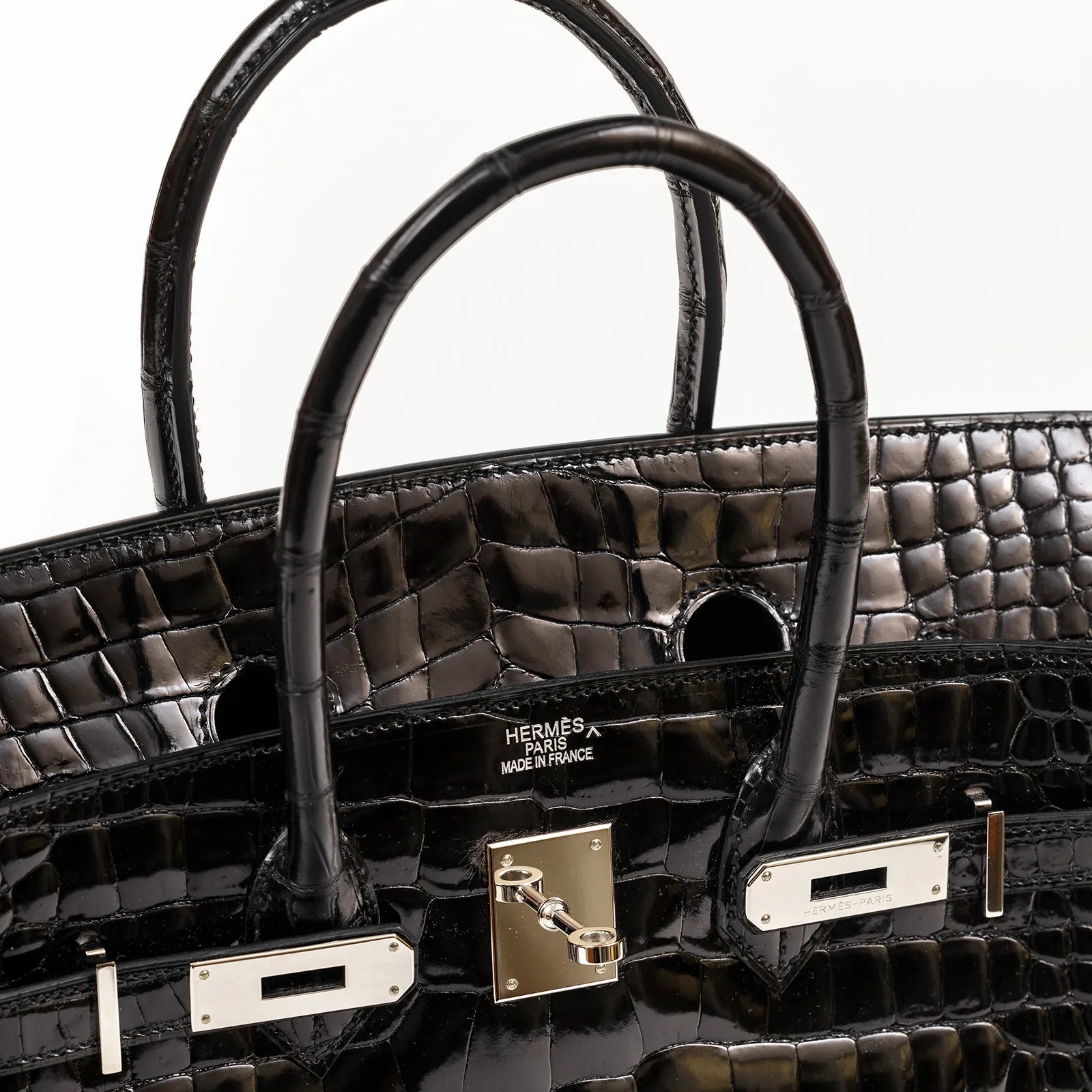 Close-up front view of Hermès Birkin 35 Black Shiny Porosus leather with palladium hardware details.