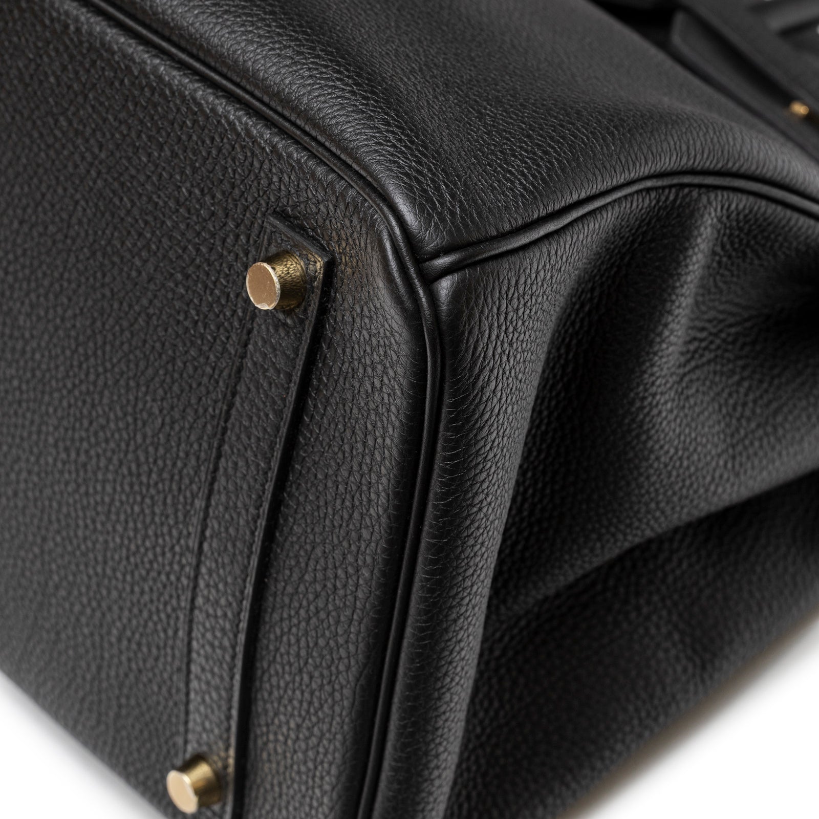 Close-up detail of the bottom corner showing black Togo leather and gold hardware on Hermès Birkin 35 Black Togo Gold Hardware