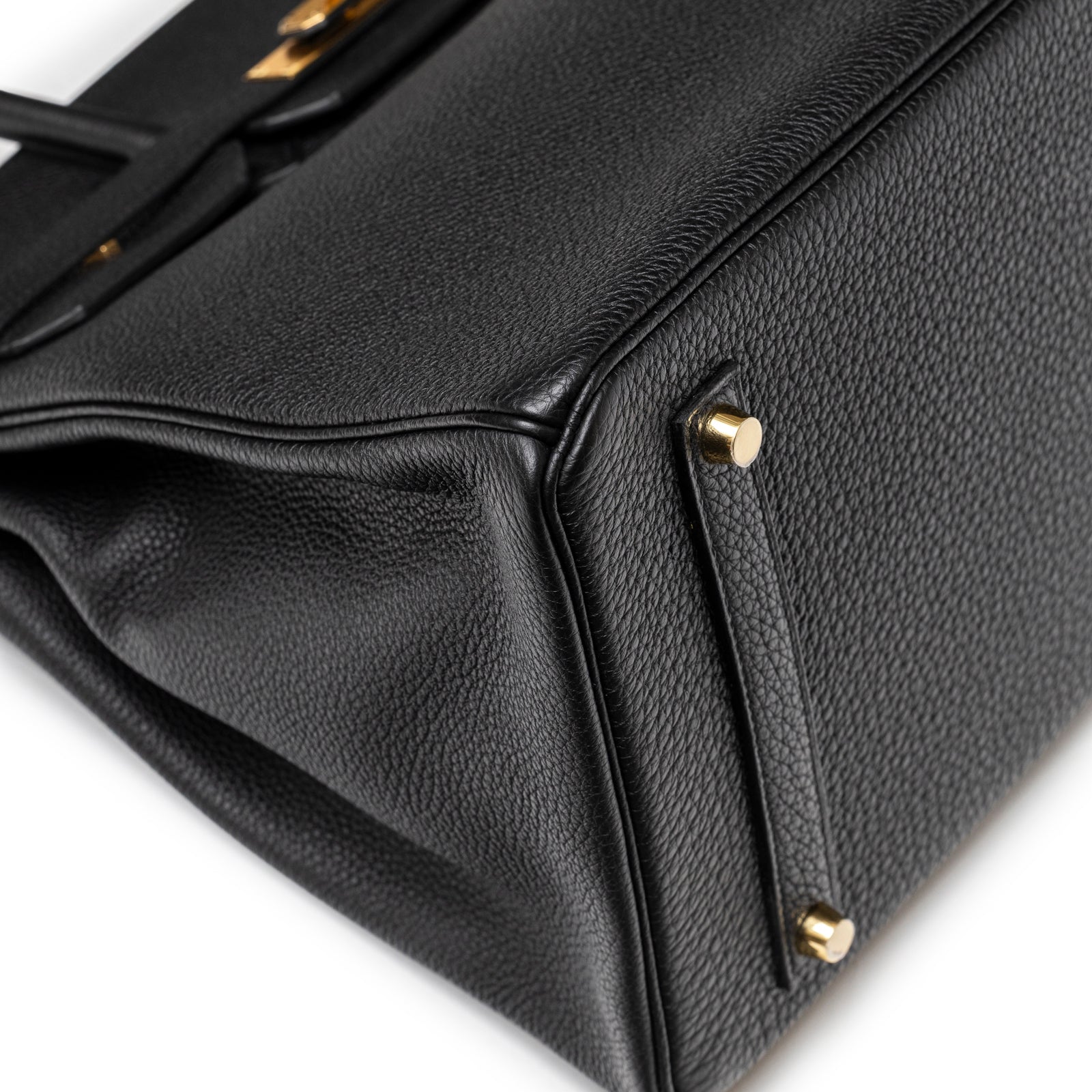 Close-up of Hermès Birkin 35 Black Togo Gold Hardware showing textured leather base corner with gold feet details