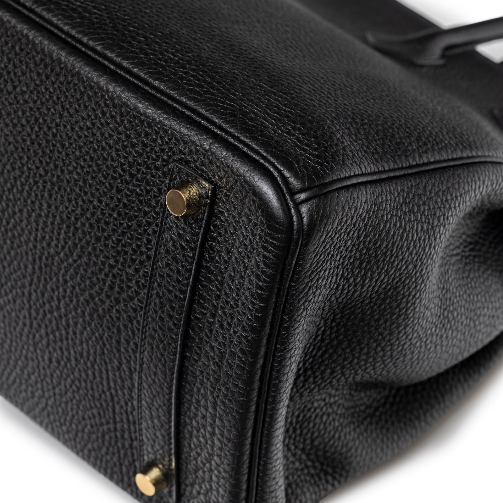 Close-up of Hermès Birkin 35 Black Togo Gold Hardware bottom corner showing pebbled leather and gold studs