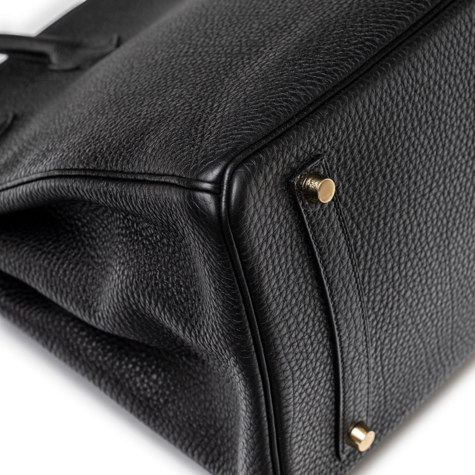 Close-up of base corner and gold feet on Hermès Birkin 35 Black Togo Gold Hardware handbag showing texture