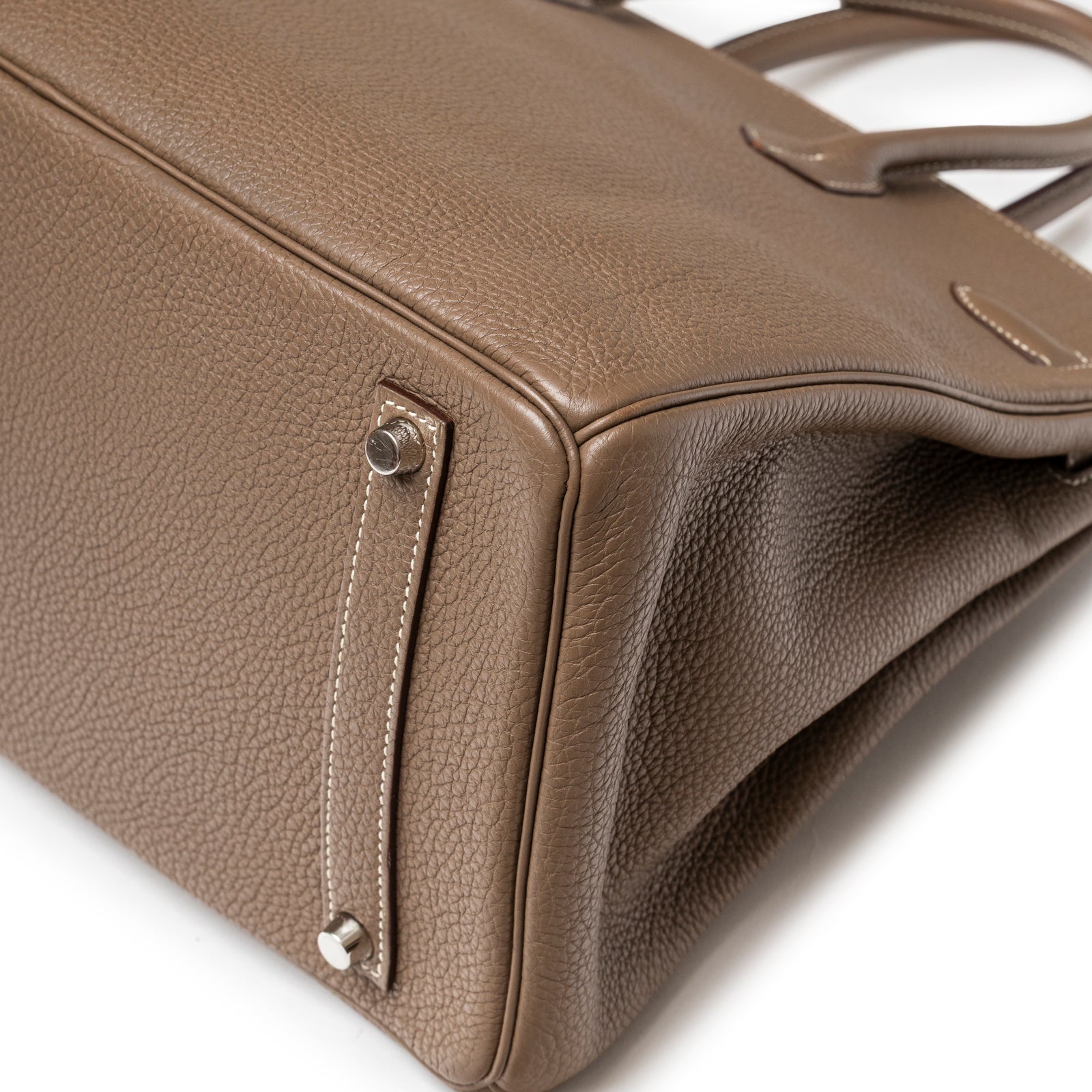 Close-up angled view of Hermès Birkin 35 Etoupe Togo Palladium Hardware showing textured leather and side strap stitching detail