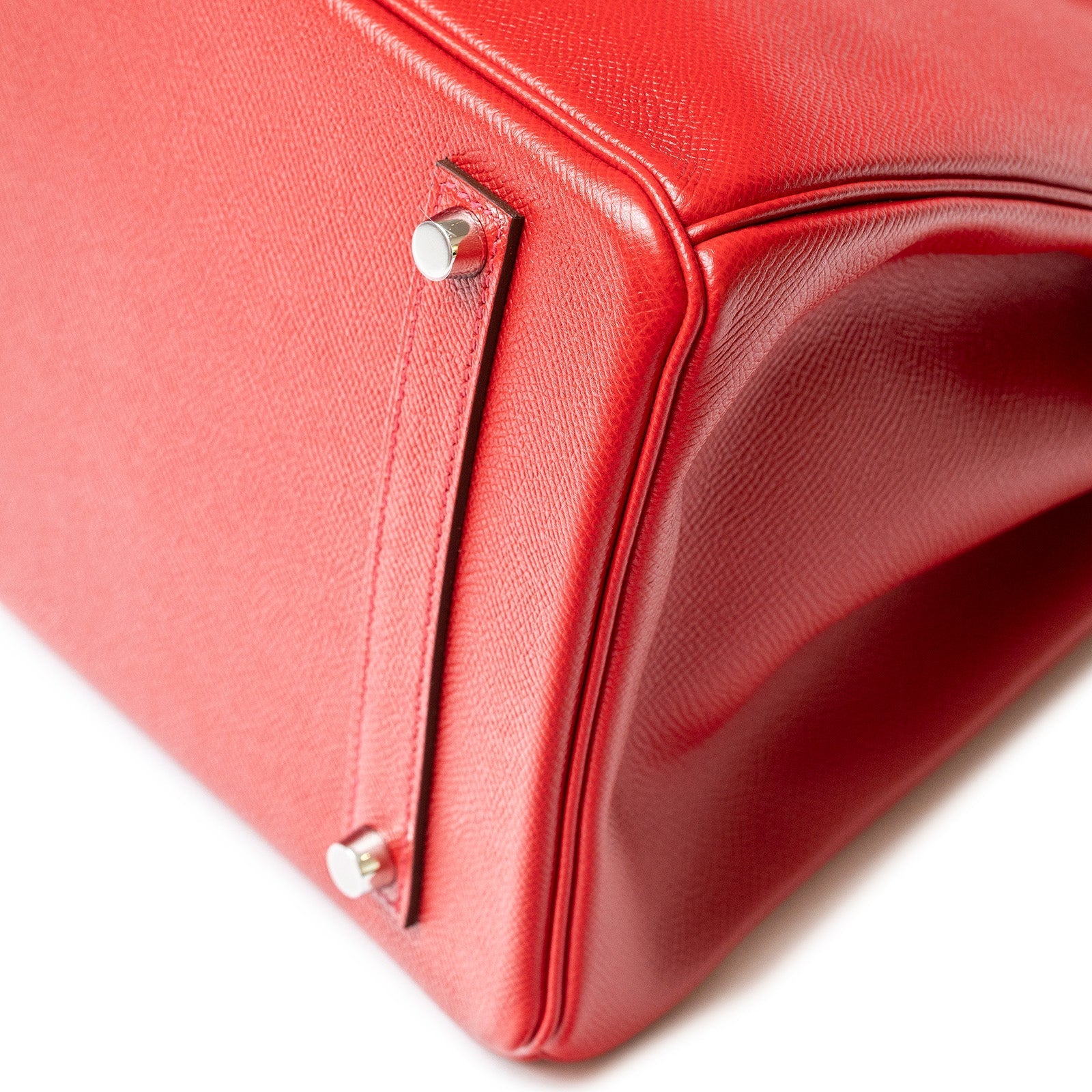 Close-up of base corner and palladium hardware on Hermès Birkin 35 Rouge Casaque Epsom leather bag.