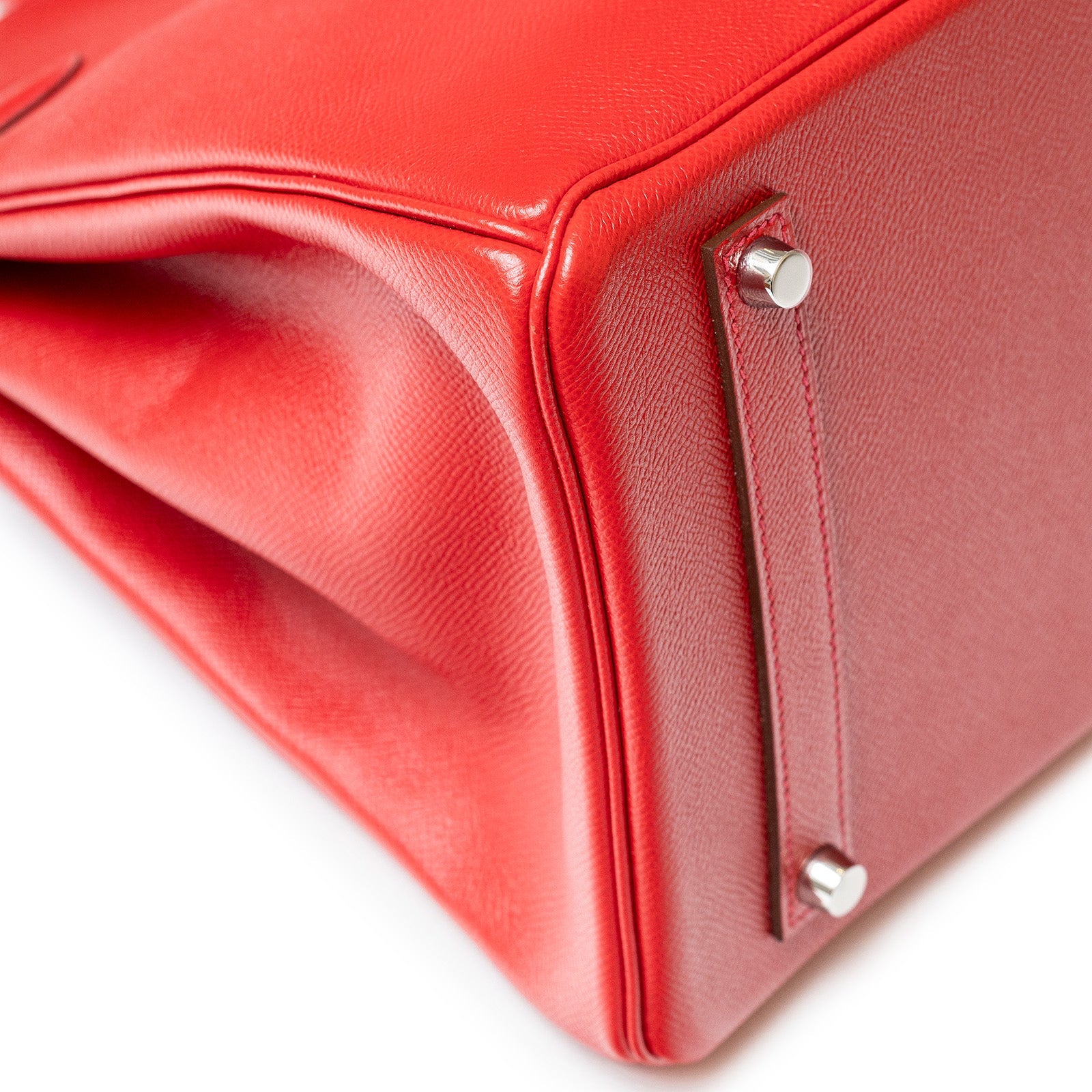 Close-up of bottom corner and palladium hardware on Hermès Birkin 35 Rouge Casaque Epsom leather bag