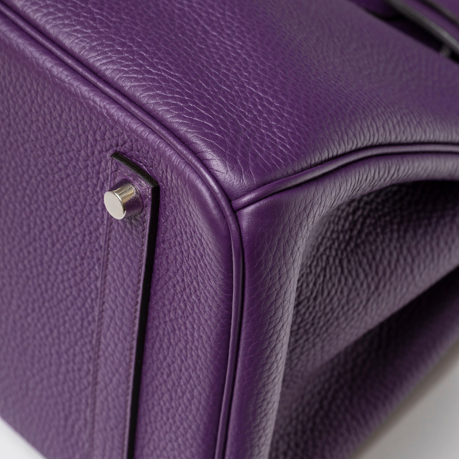 Close-up of bottom corner showing pebbled violet leather and palladium feet on Hermès Birkin 35 Violet Togo Palladium Hardware