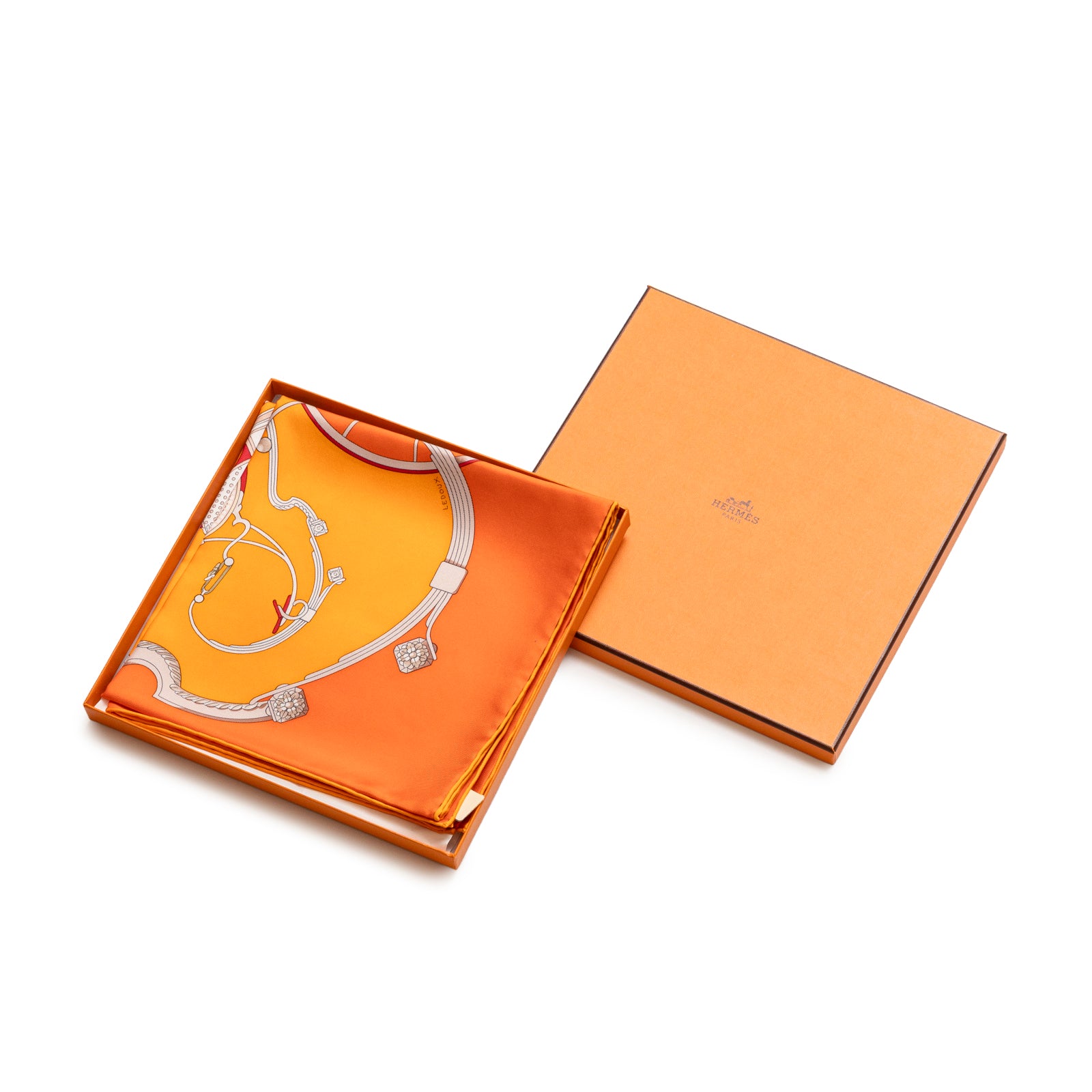 Folded Hermès Carre 90 Springs Silk Scarf Capucine Orange Blanc in orange box with silver chain design visible