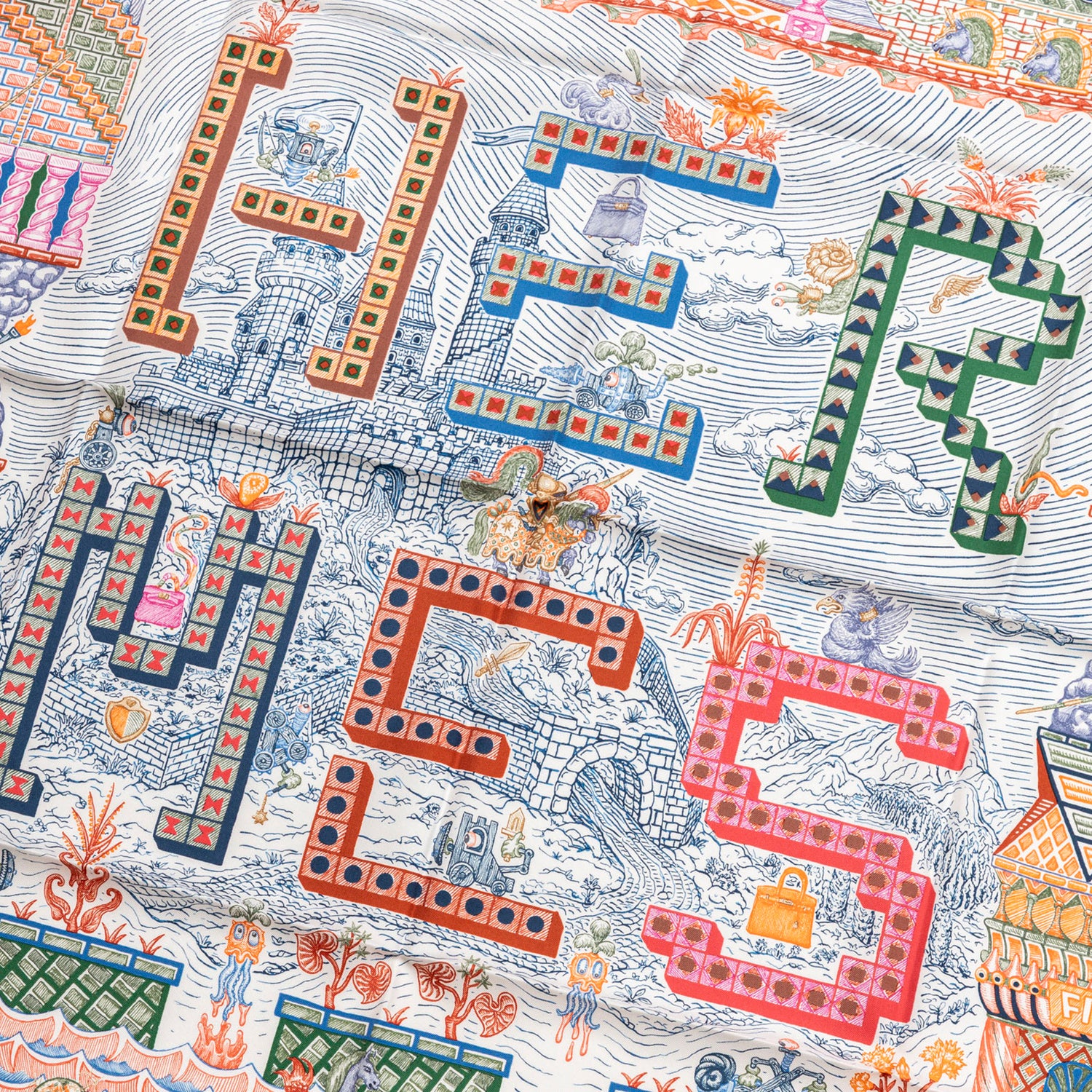 Close-up of colorful playful letters in checkered pattern on Hermès Carre 90 Super Silk Quest Blue Roy Rose Multicolor scarf