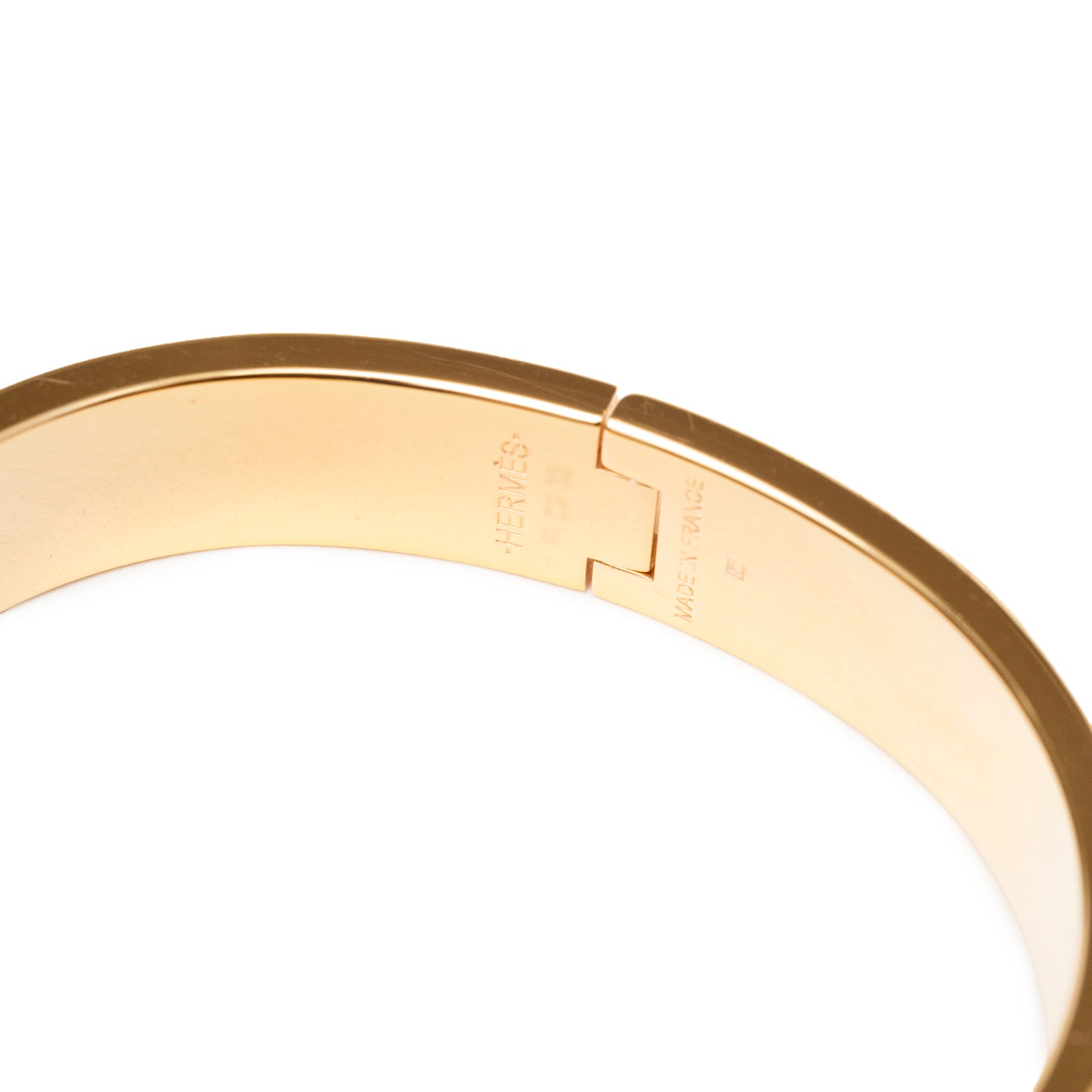 Close-up of inside hinge and engraved markings on Hermès Clic H bracelet PM Pink Gold Hardware