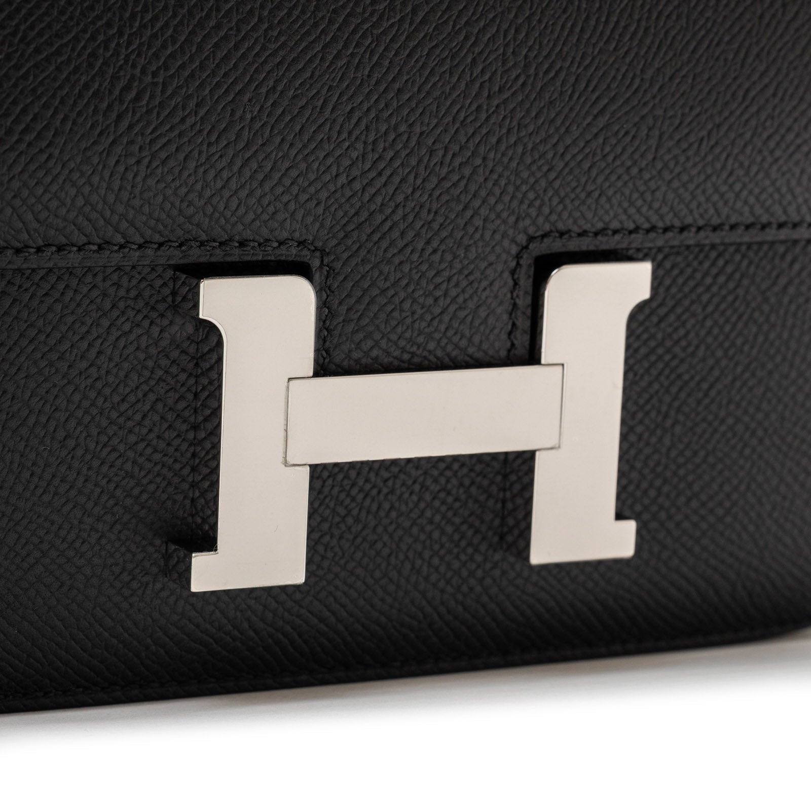 Close-up of palladium hardware clasp on Hermès Constance 18 Black Epsom Palladium Hardware handbag showing texture details