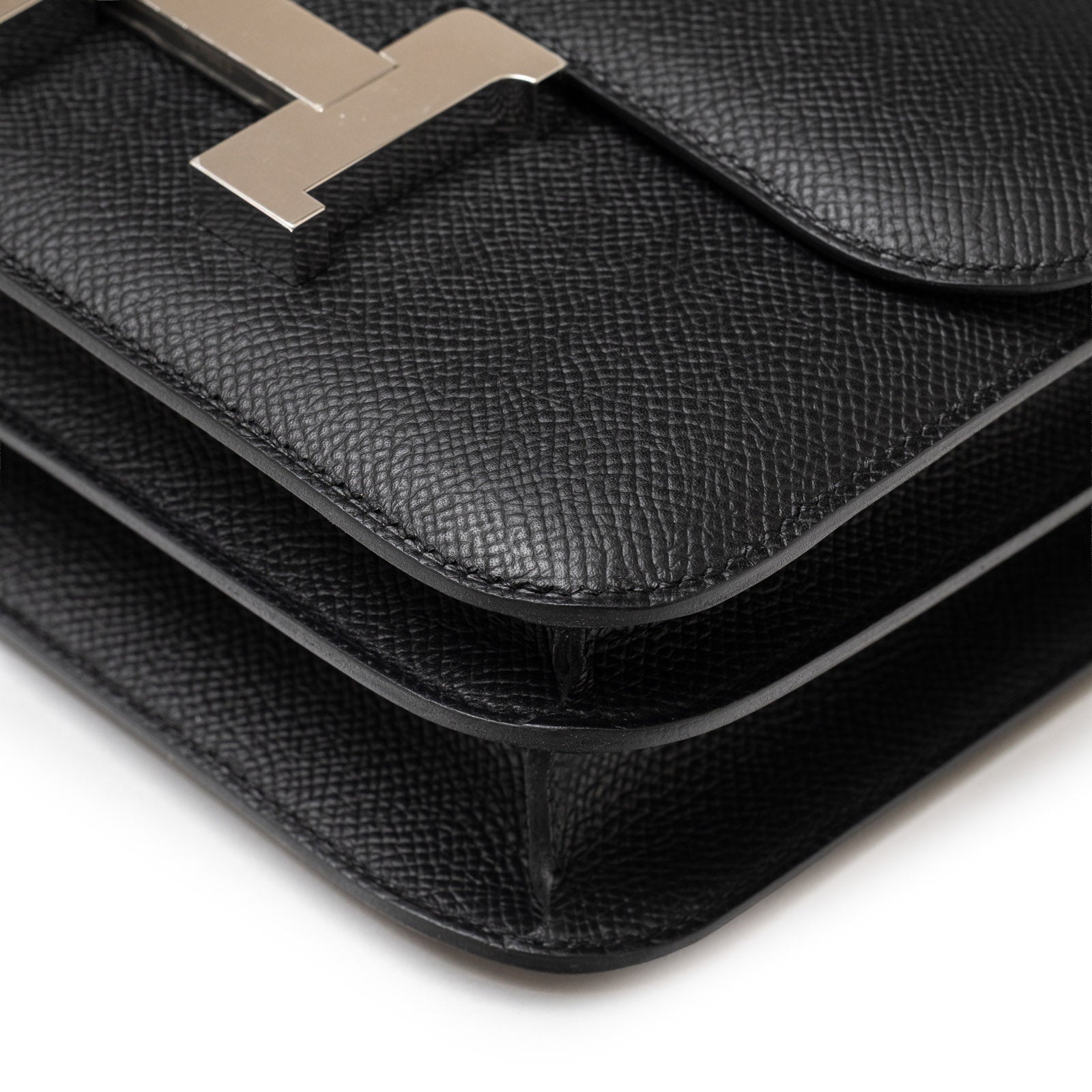 Close-up angled view of Hermès Constance 18 Black Epsom Palladium Hardware showing texture and stitching details