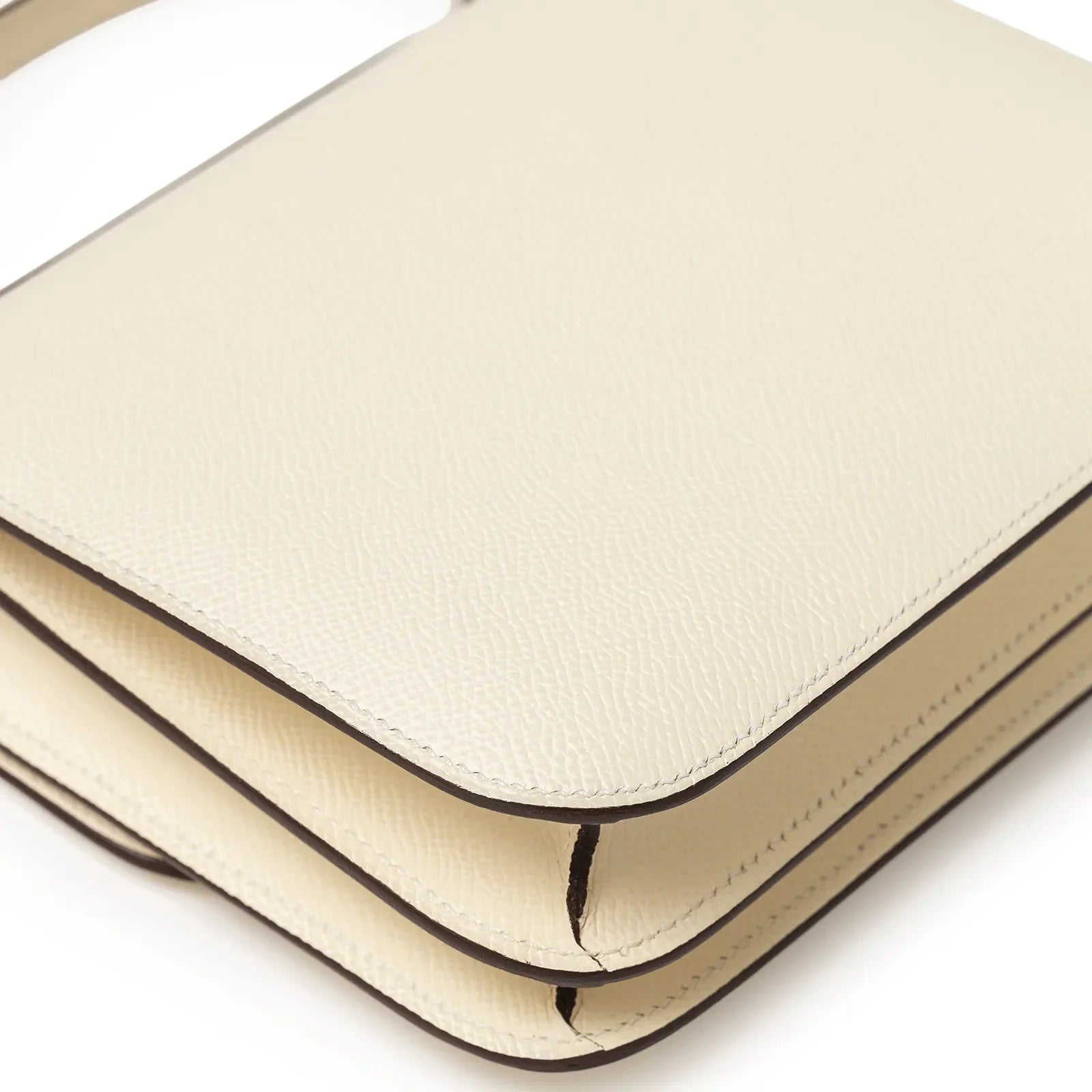 Close-up detail of Hermès Mini Constance 18 Nata Epsom Palladium Hardware corner stitching and texture view