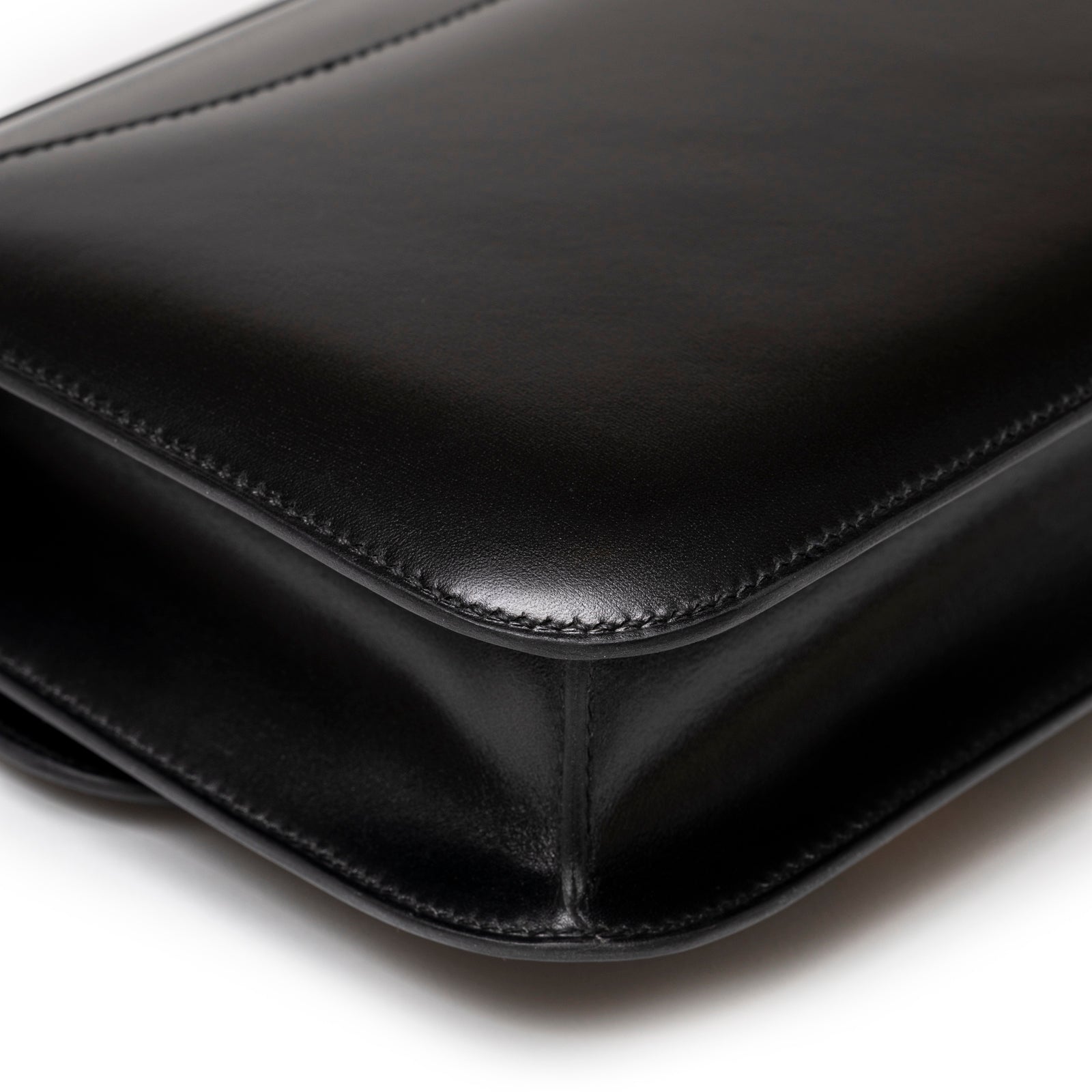 Close-up of smooth leather corner and meticulous stitching on Hermès Constance 24 Black Box Gold Hardware handbag
