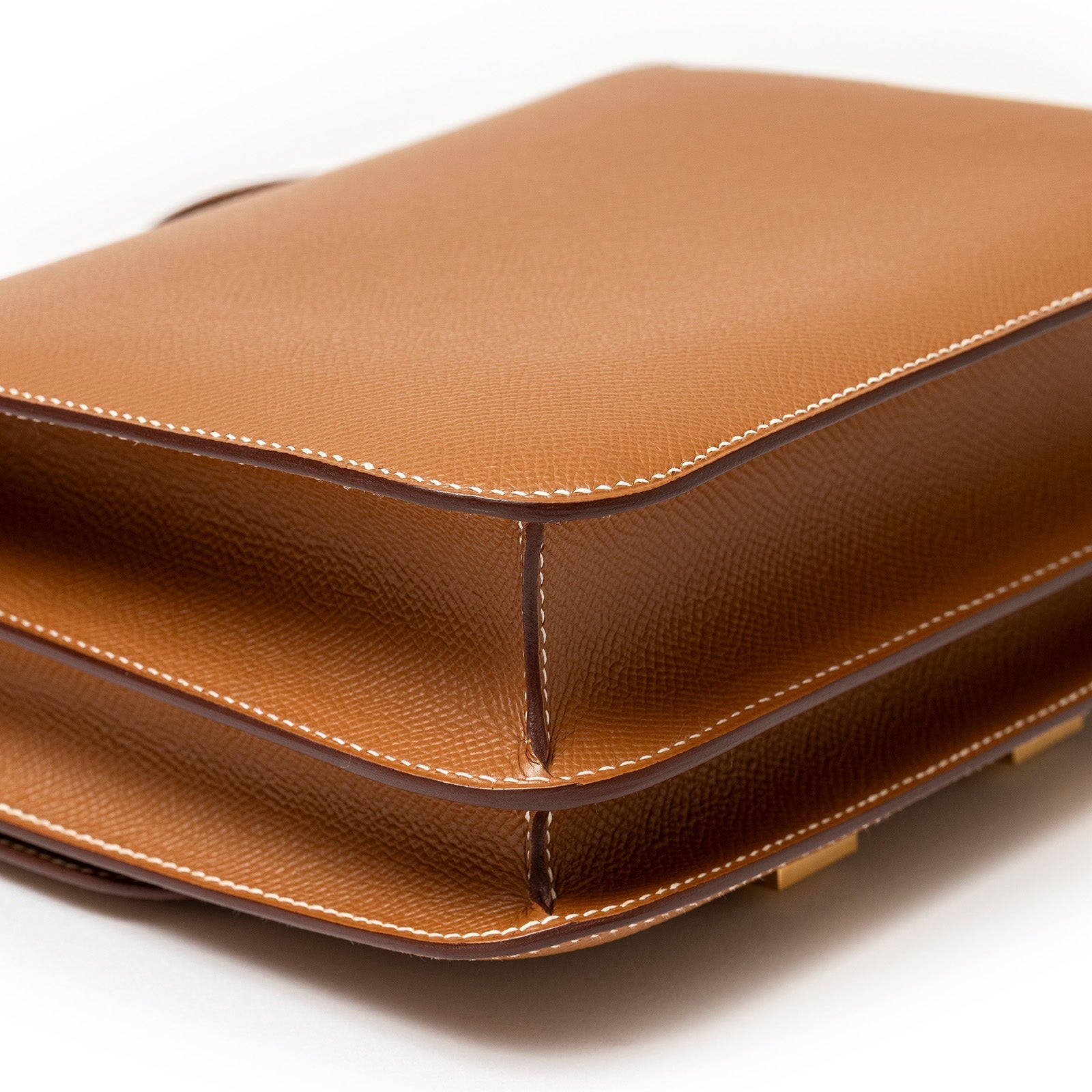 Close-up angled view of Hermès Constance 24 Gold Epsom Gold Hardware highlighting leather texture and stitching