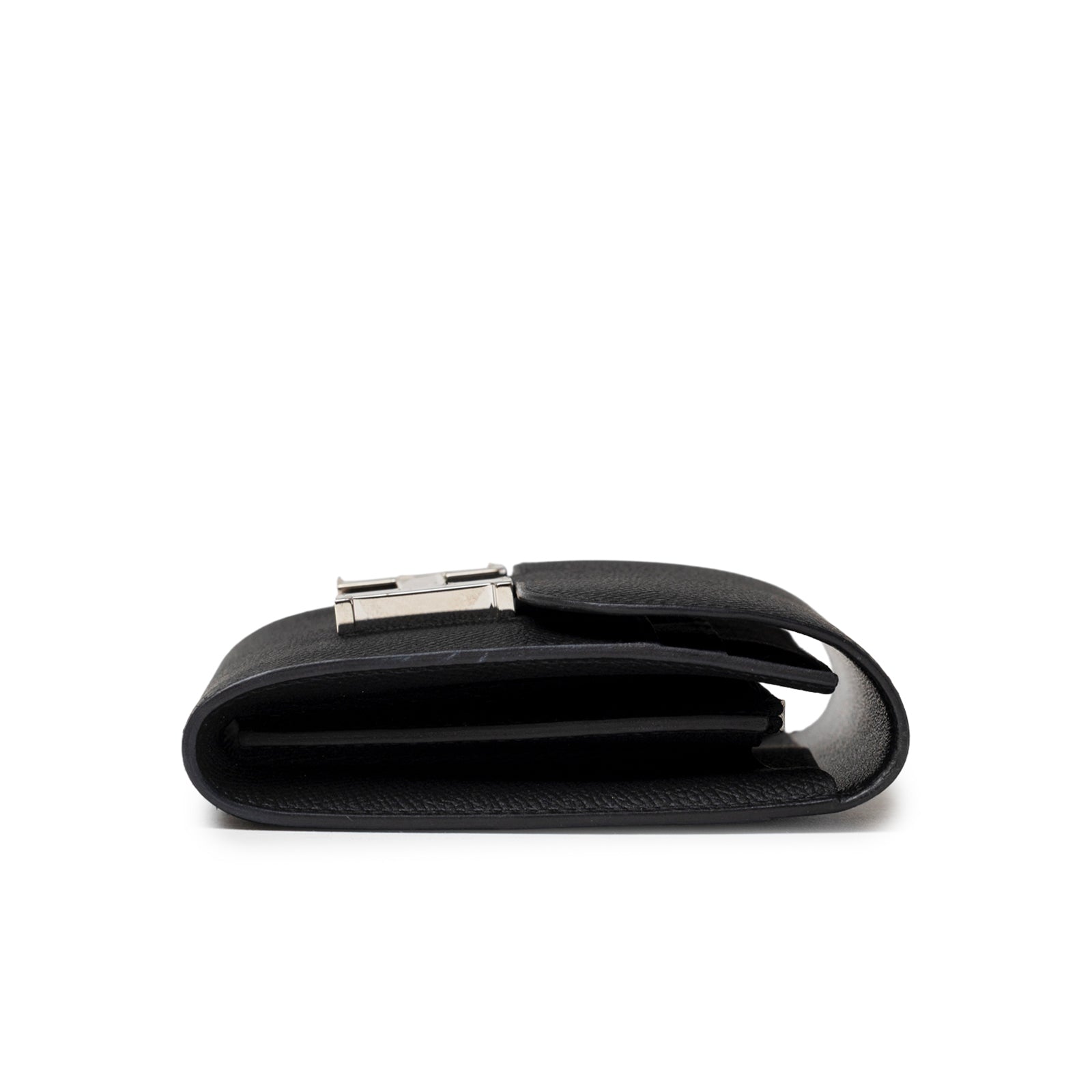 Side profile of Hermès Constance Compact Wallet Black Epsom Palladium Hardware showing folded leather and clasp detail