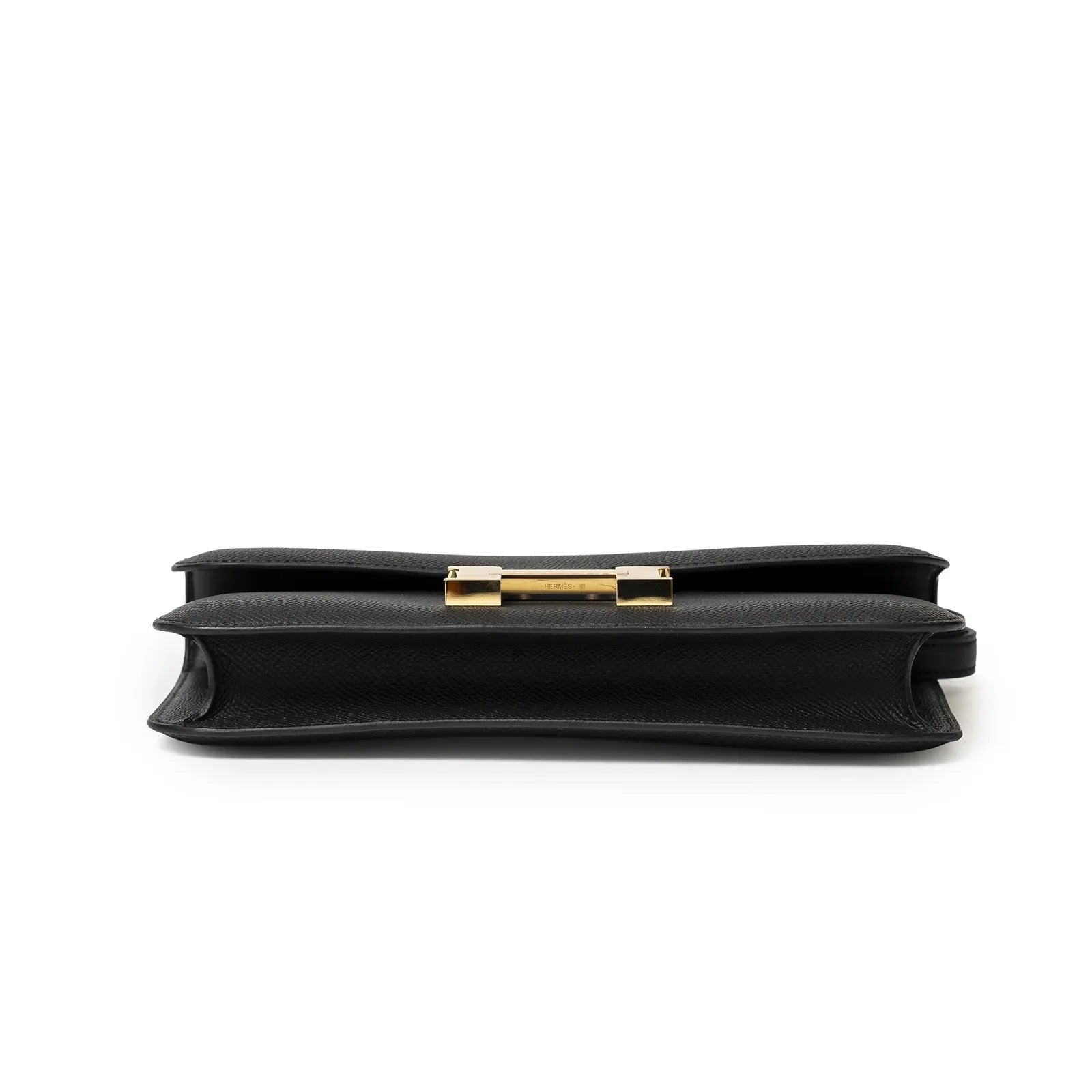 Bottom close-up view of Hermès Constance Elan Black Epsom Gold Hardware showing structured edges and clasp details