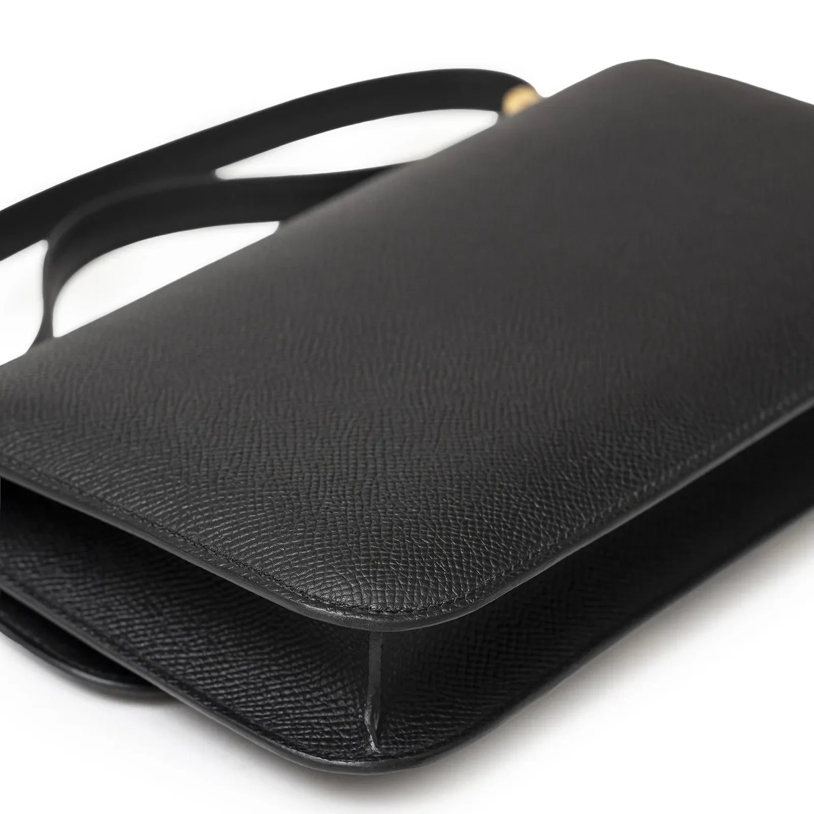 Angled close-up of Hermès Constance Elan Black Epsom Gold Hardware showing textured leather and sleek design