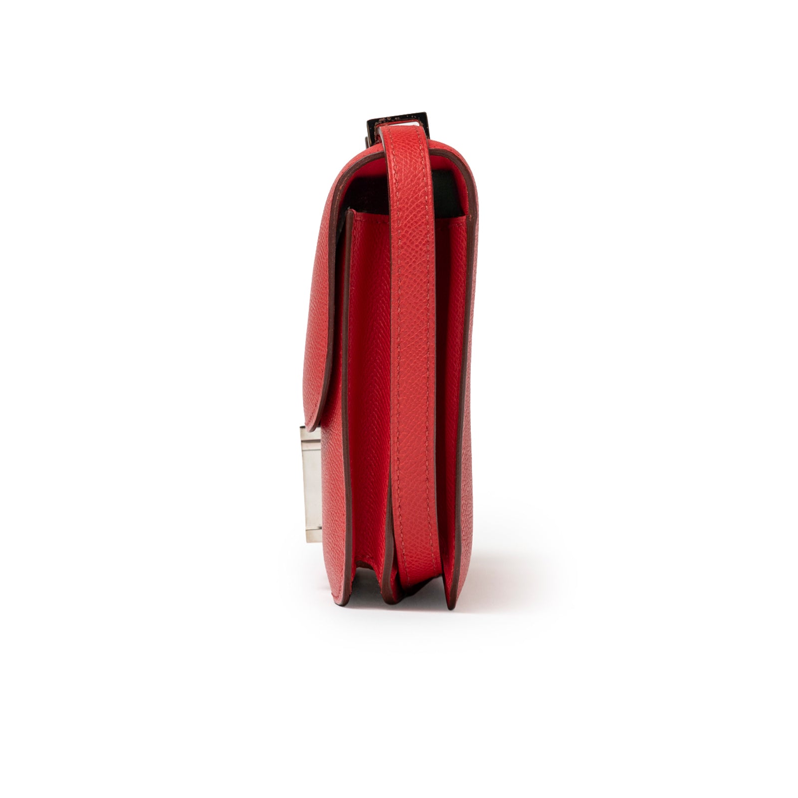 Side profile of Hermès Constance Elan Rouge Epsom Palladium Hardware showing slim red leather and strap edge details
