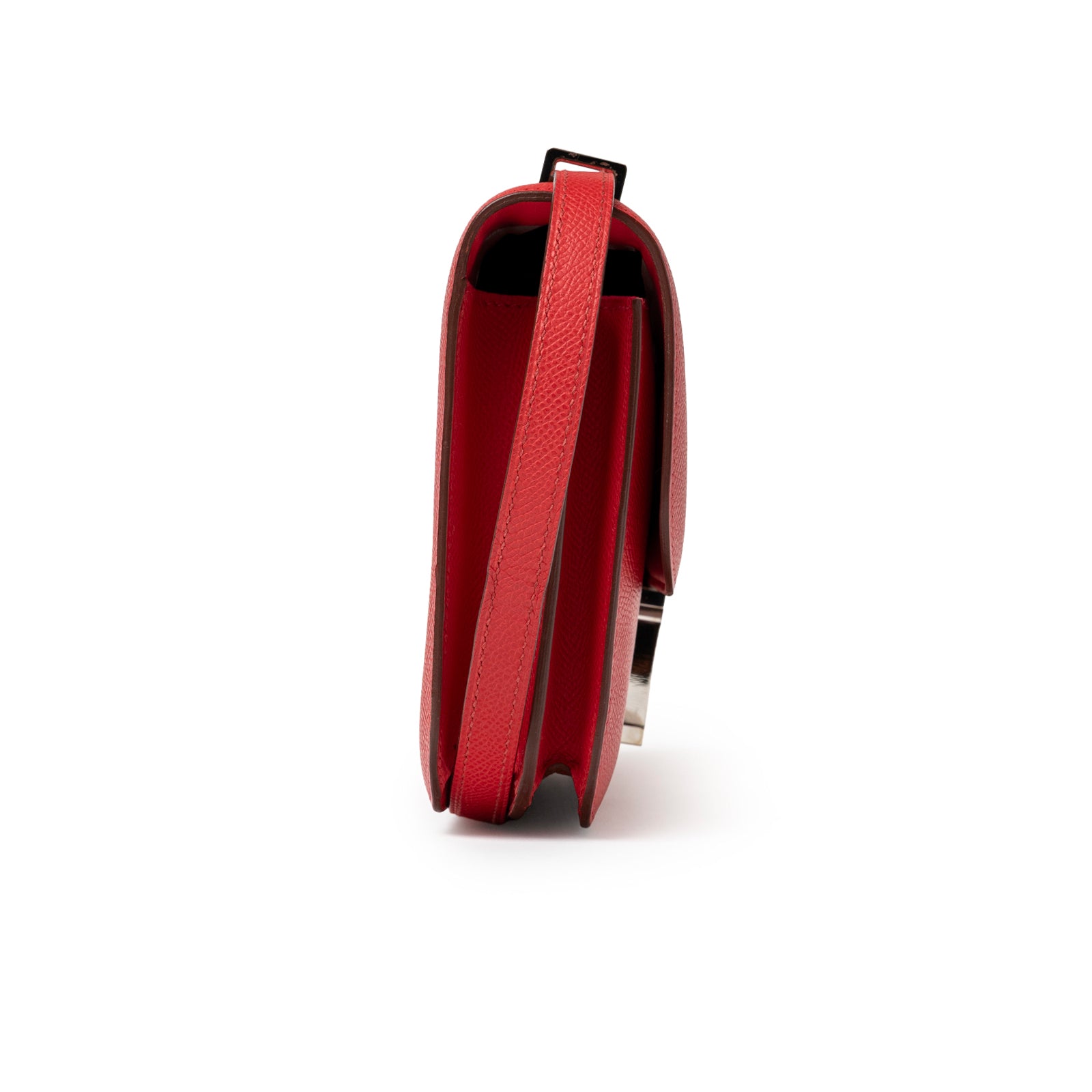 Side perspective of Hermès Constance Elan Rouge Epsom Palladium Hardware showing slim profile and strap texture detail