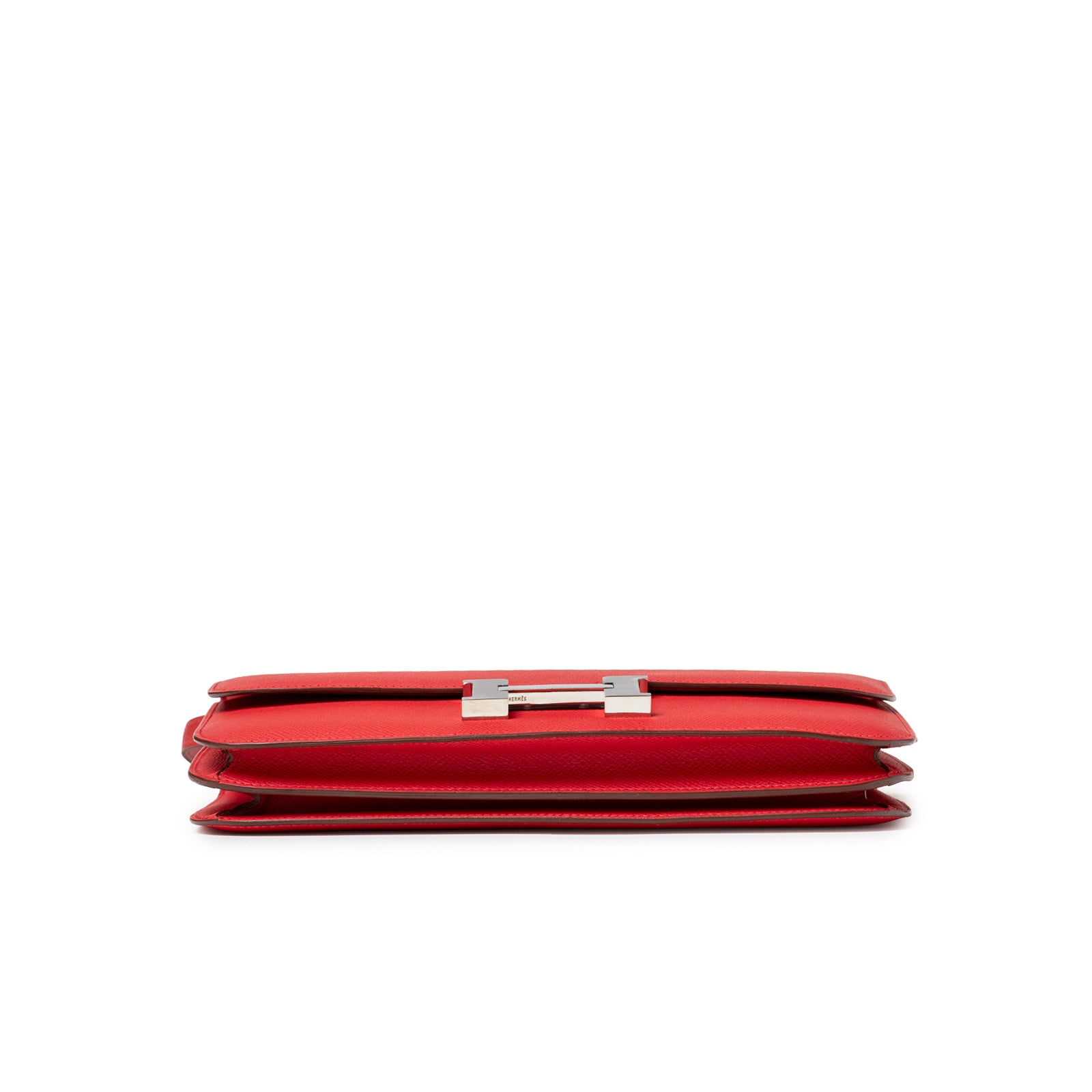 Low profile side view of Hermès Constance Elan Rouge Epsom Palladium Hardware showing slim folded leather edges and clasp detail