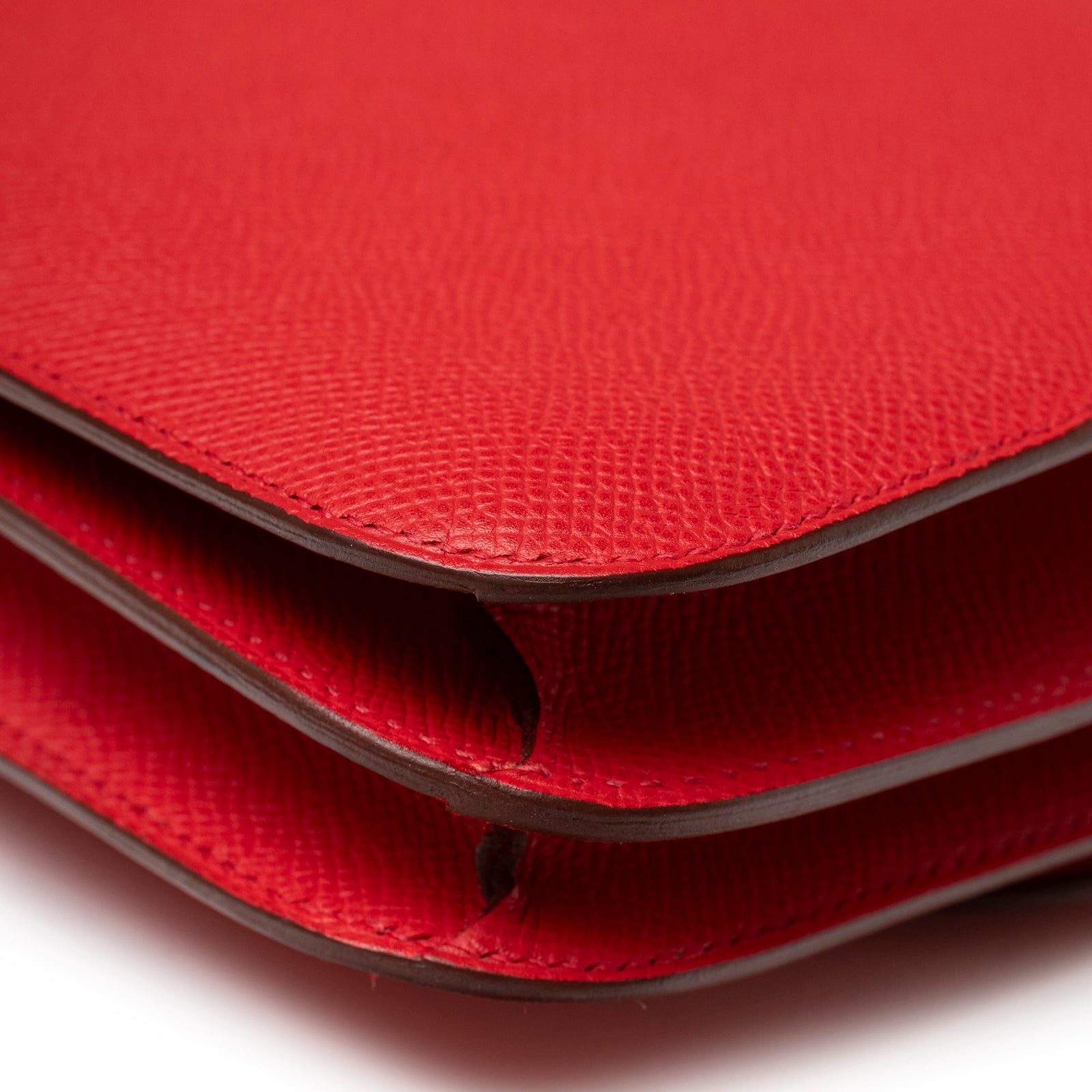 Close-up of Hermès Constance Elan Rouge Epsom Palladium Hardware showing textured leather and folded edge detail