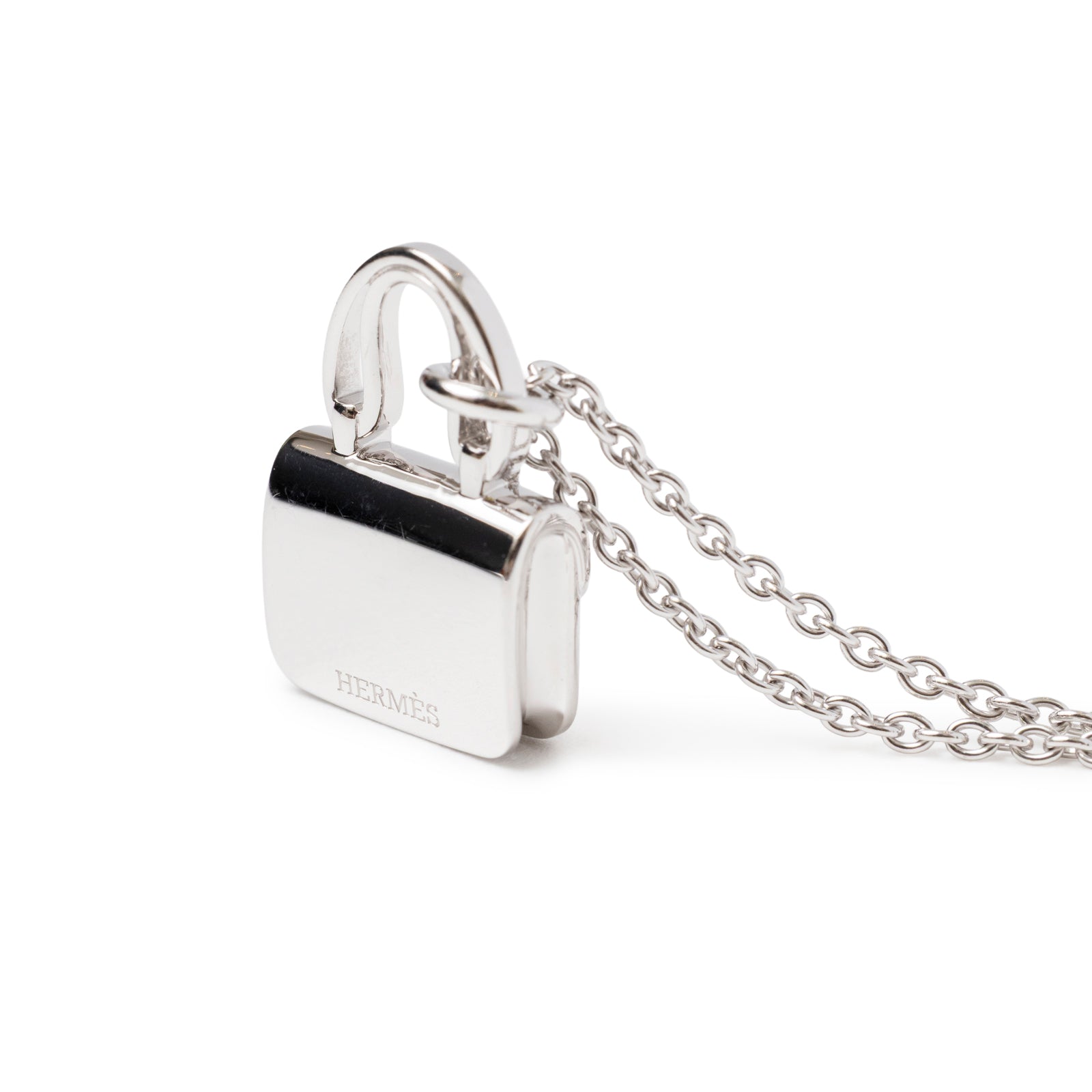 Close-up side view of Hermès Constance Pendant 18K White Gold and Diamonds with polished chain link details